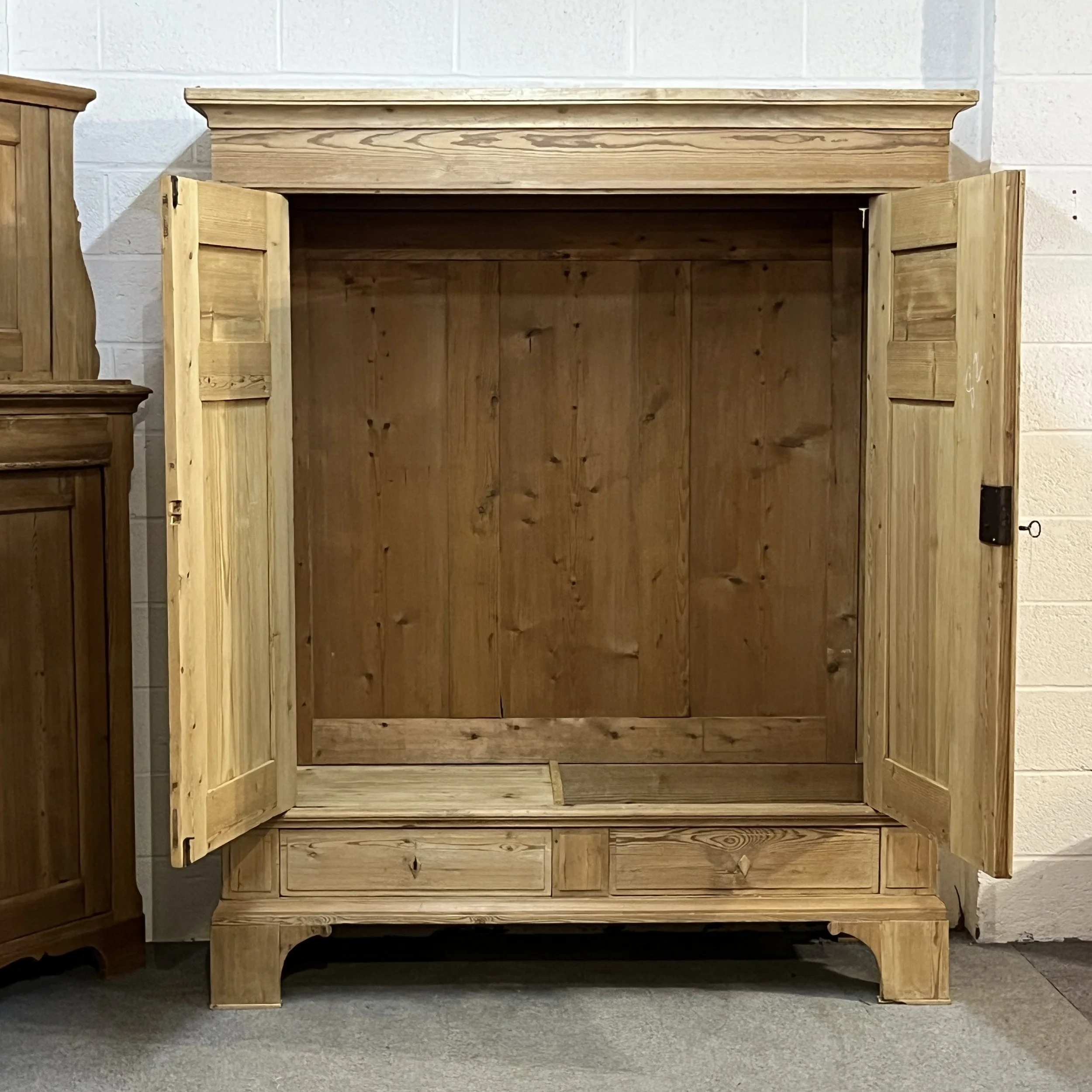 Wardrobe N8206H with both doors open, showing the empty interior, drawer compartment and right-hand footwell.