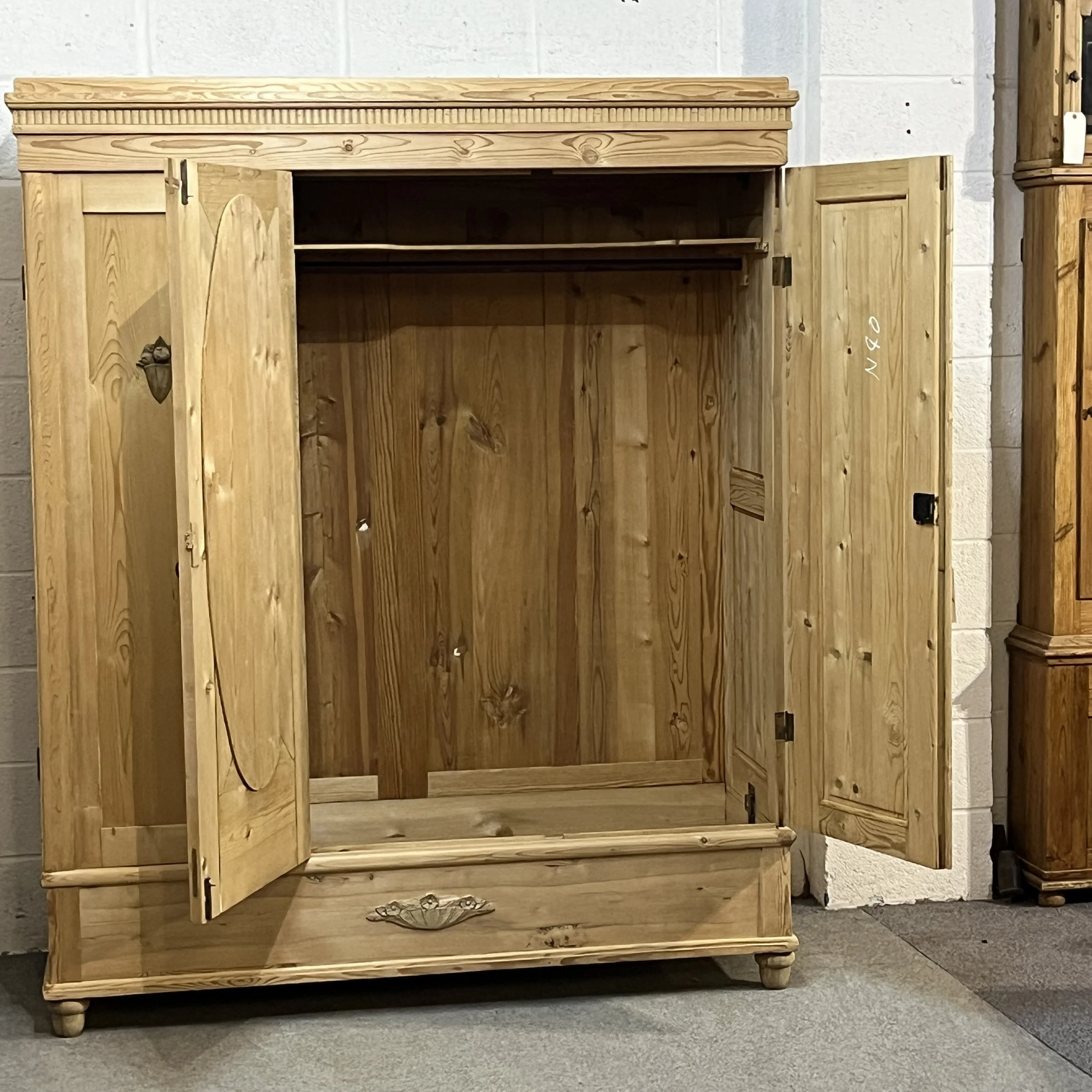 Pine wardrobe with central and right doors open to show the hanging compartment