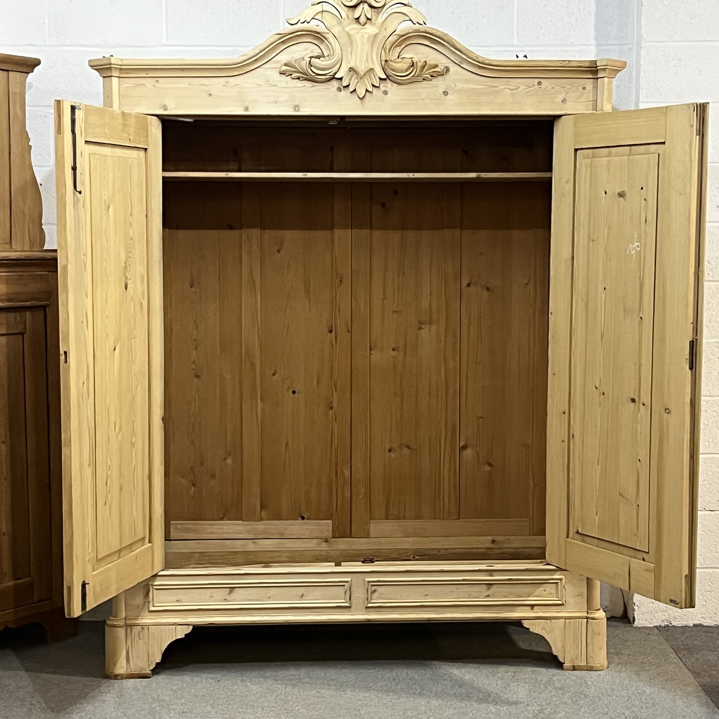 Pine double wardrobe with both doors open to show its interior and upper shelf