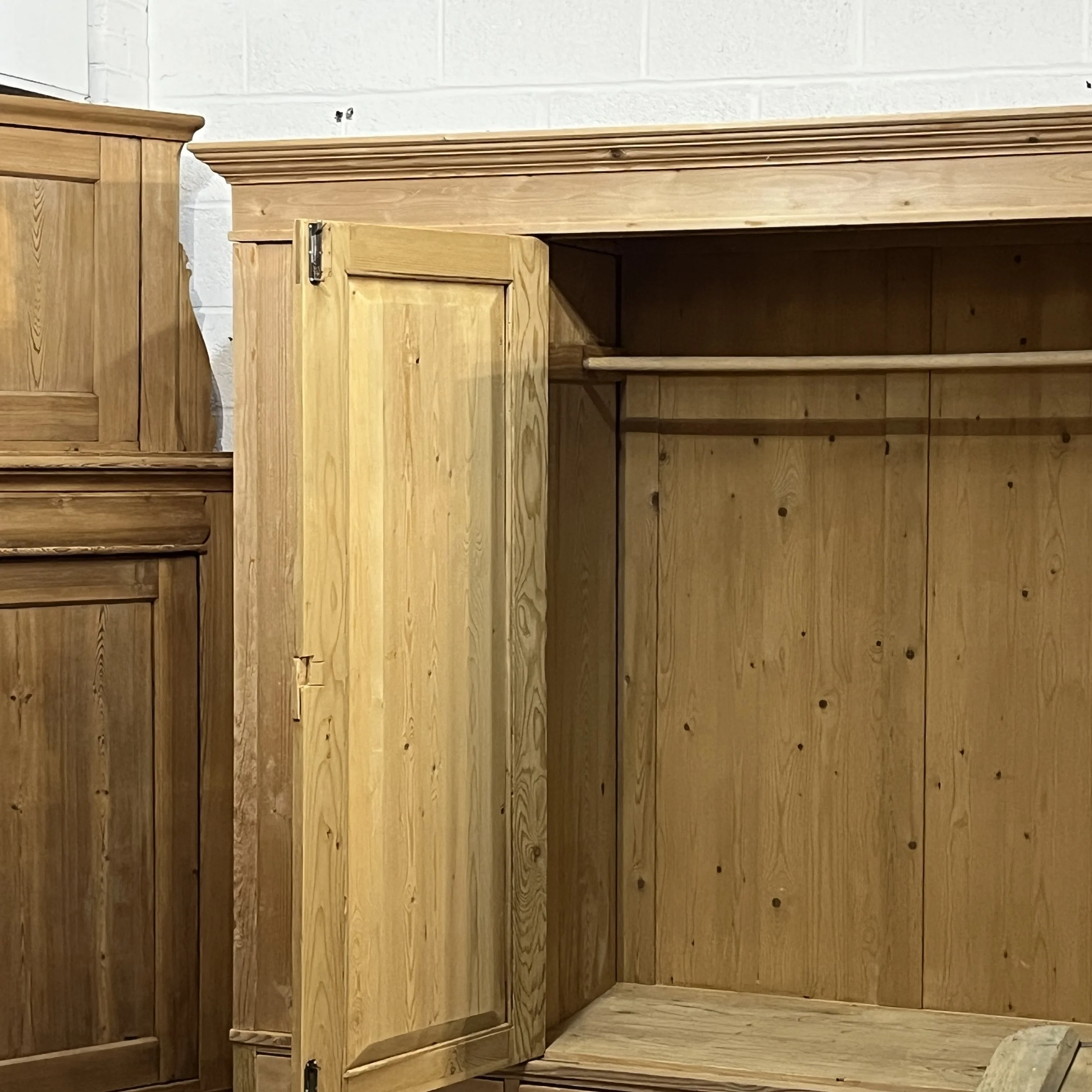 Close view of the pine wardrobe upper hanging compartment, rail and shelf