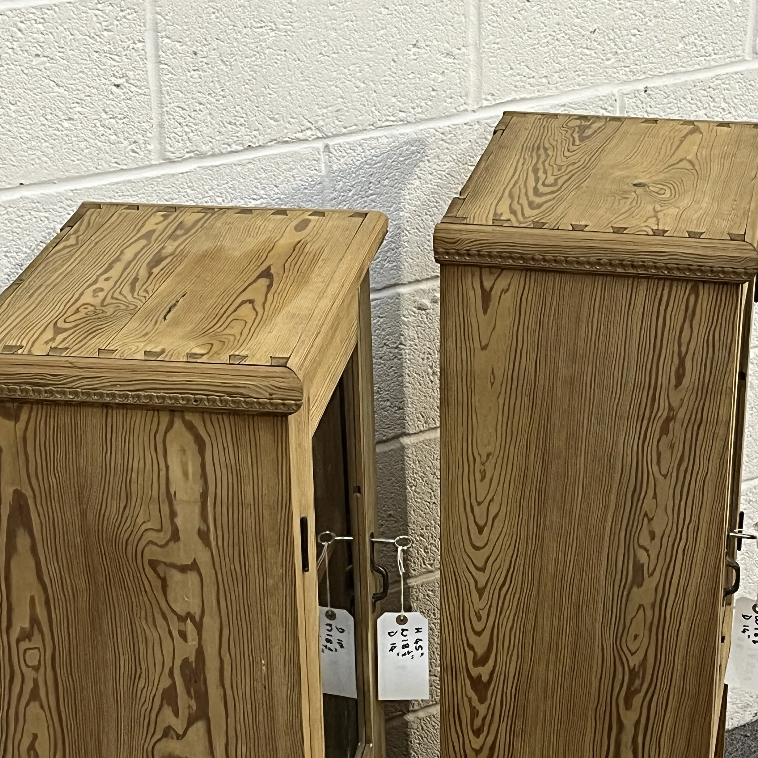 Detail of the top surfaces and wood grain on the slender pine glazed cabinets