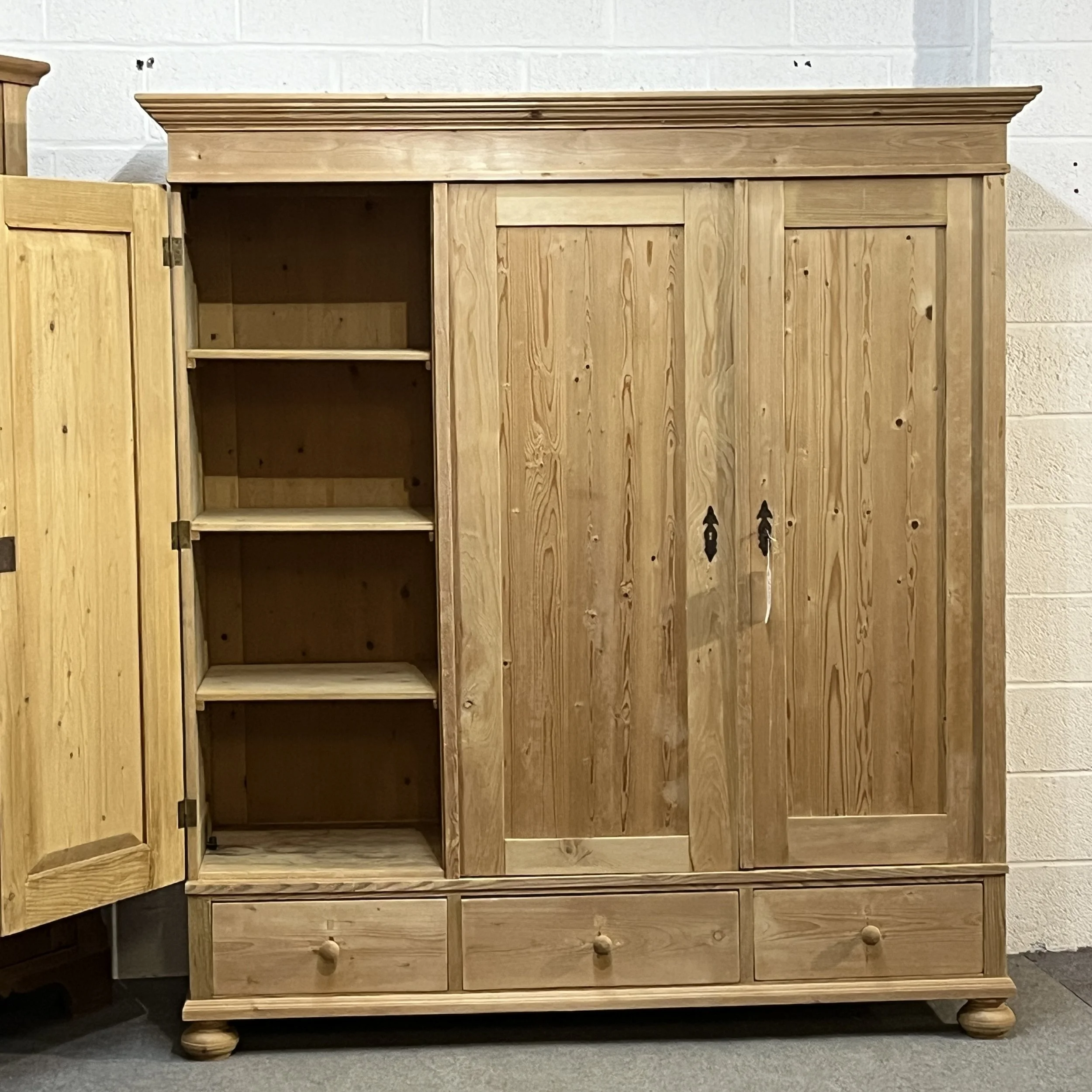 Pine triple wardrobe with left door open to show its separate shelves