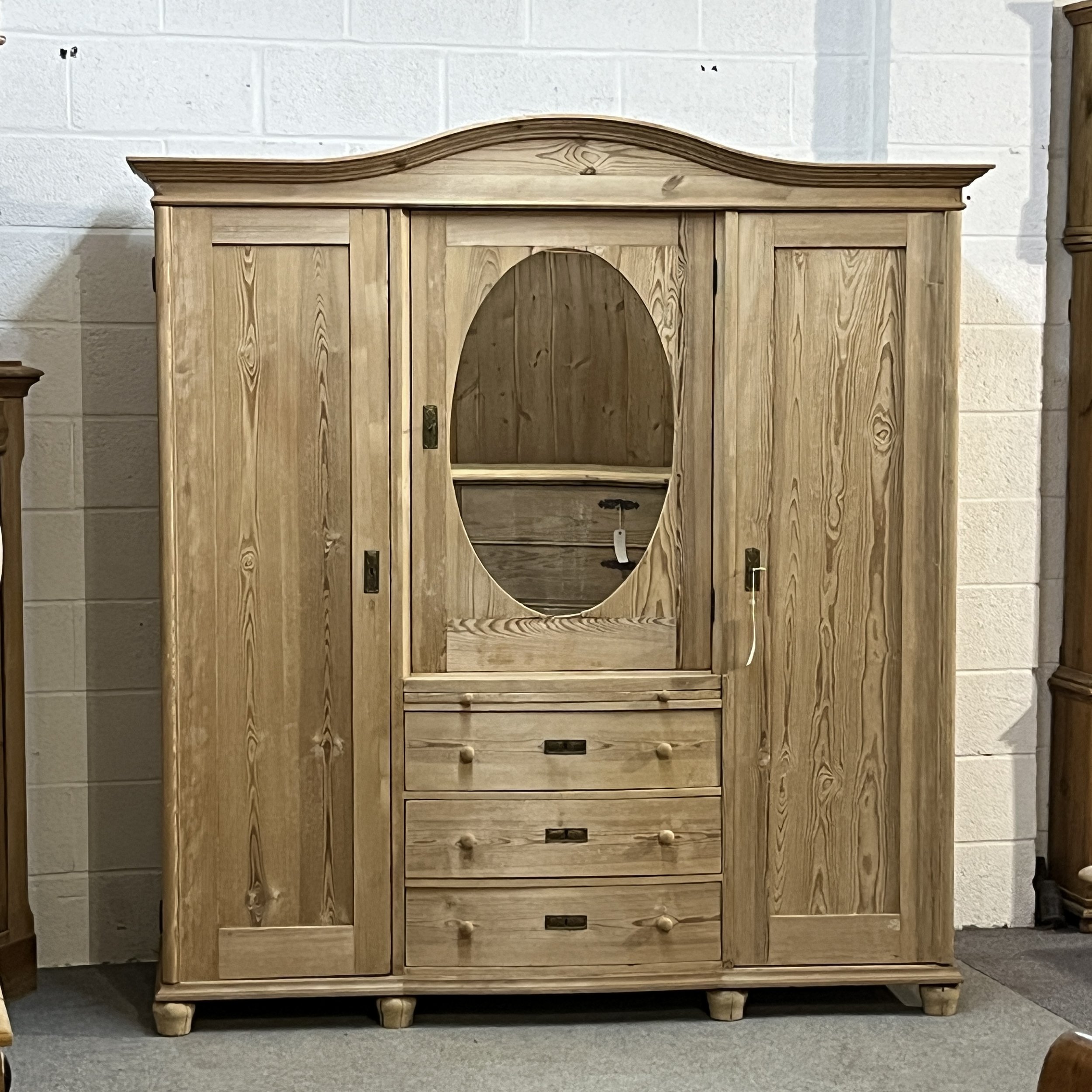 Front view of German 1930s pine combination wardrobe N4105H with oval mirror and three drawers
