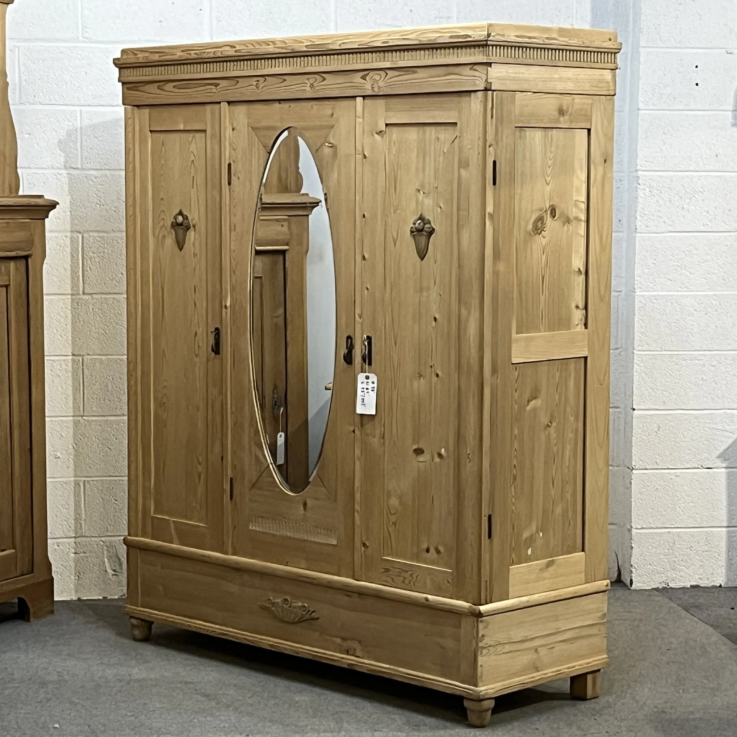Angled view of the mirrored pine wardrobe showing its right side