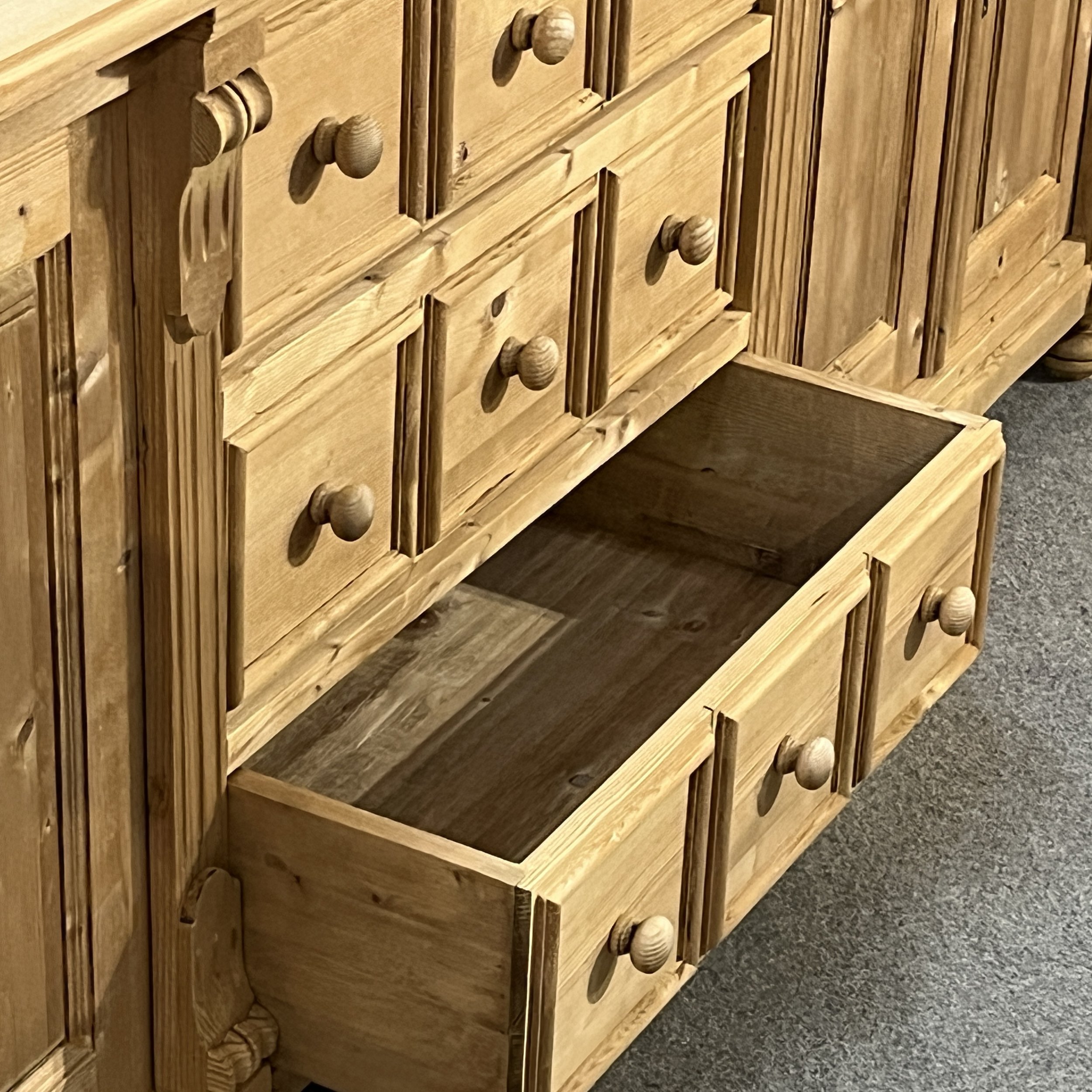 Open lower full-width drawer on pine sideboard N7102E with three-panel drawer front