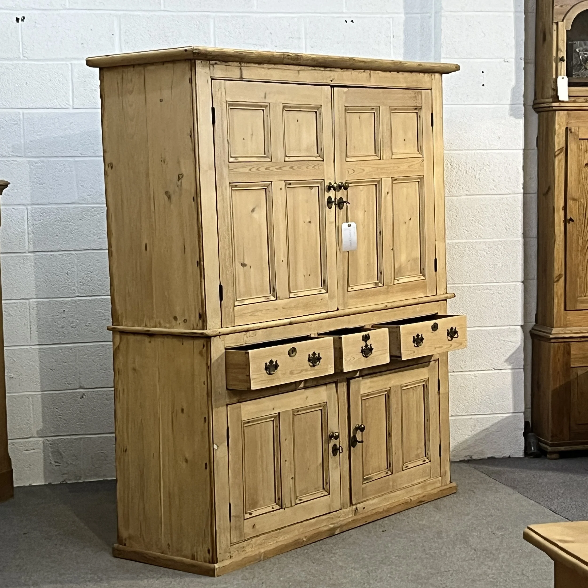 Pine housekeeper’s cupboard N7700I viewed from the left with three drawers open