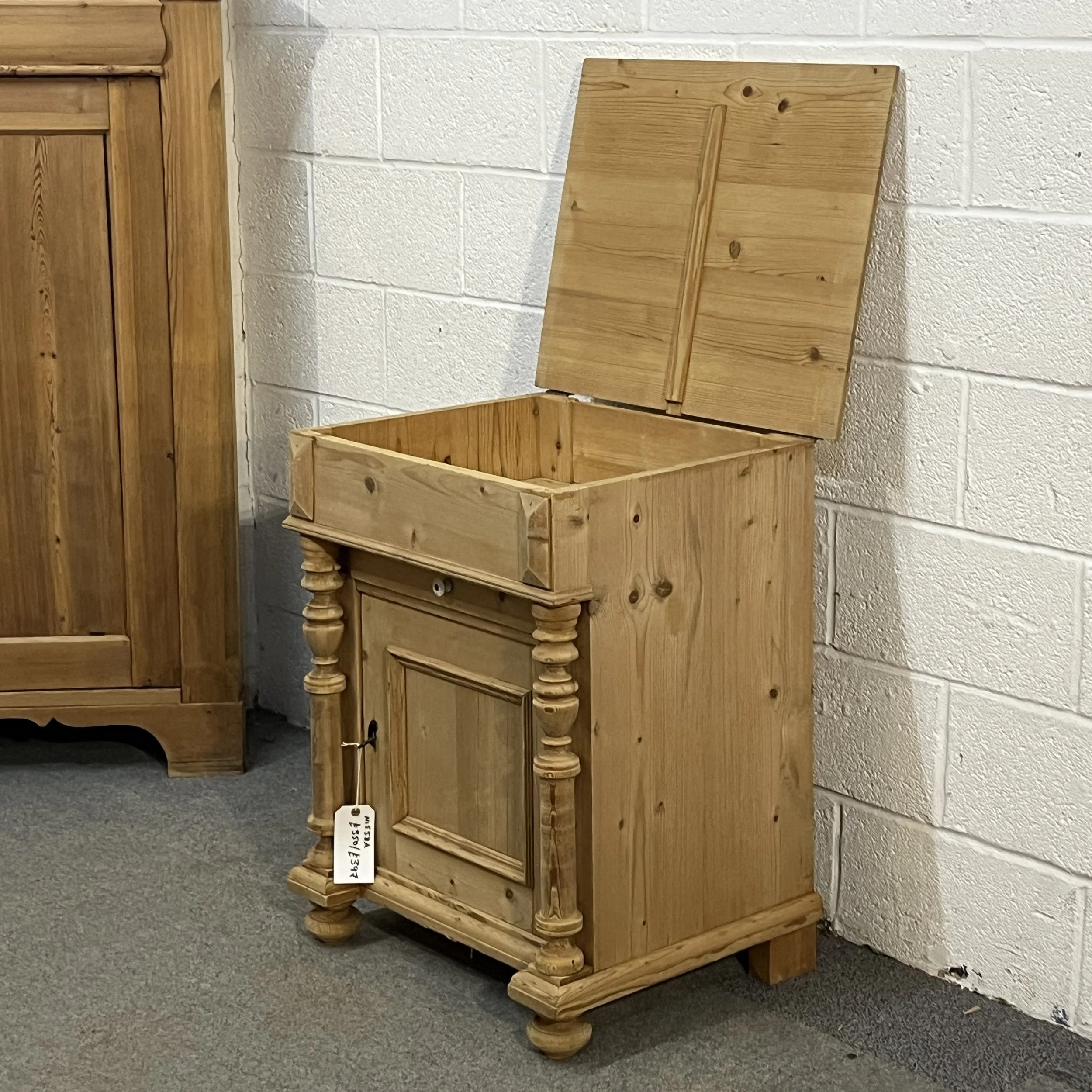 Angled view of the antique pine wash cupboard with lift-up storage open