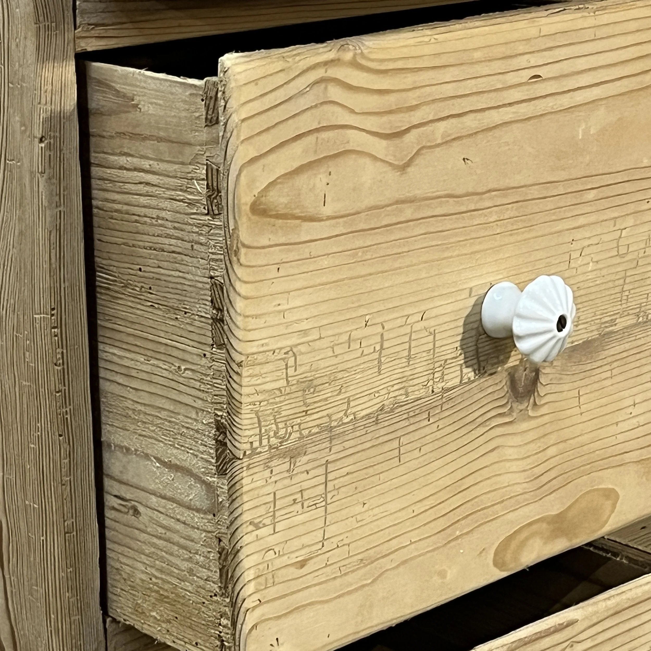 Close detail of dovetail joint, white ceramic drawer knob and old wear marks on cupboard N7408C