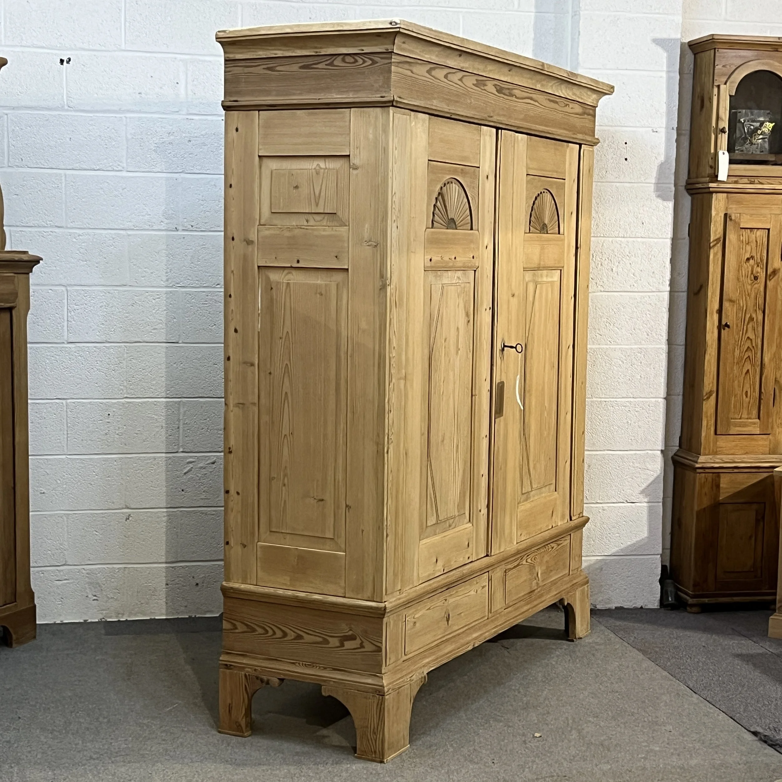 Old pine wardrobe N8206H viewed from the left, showing panelled side and detailed doors.