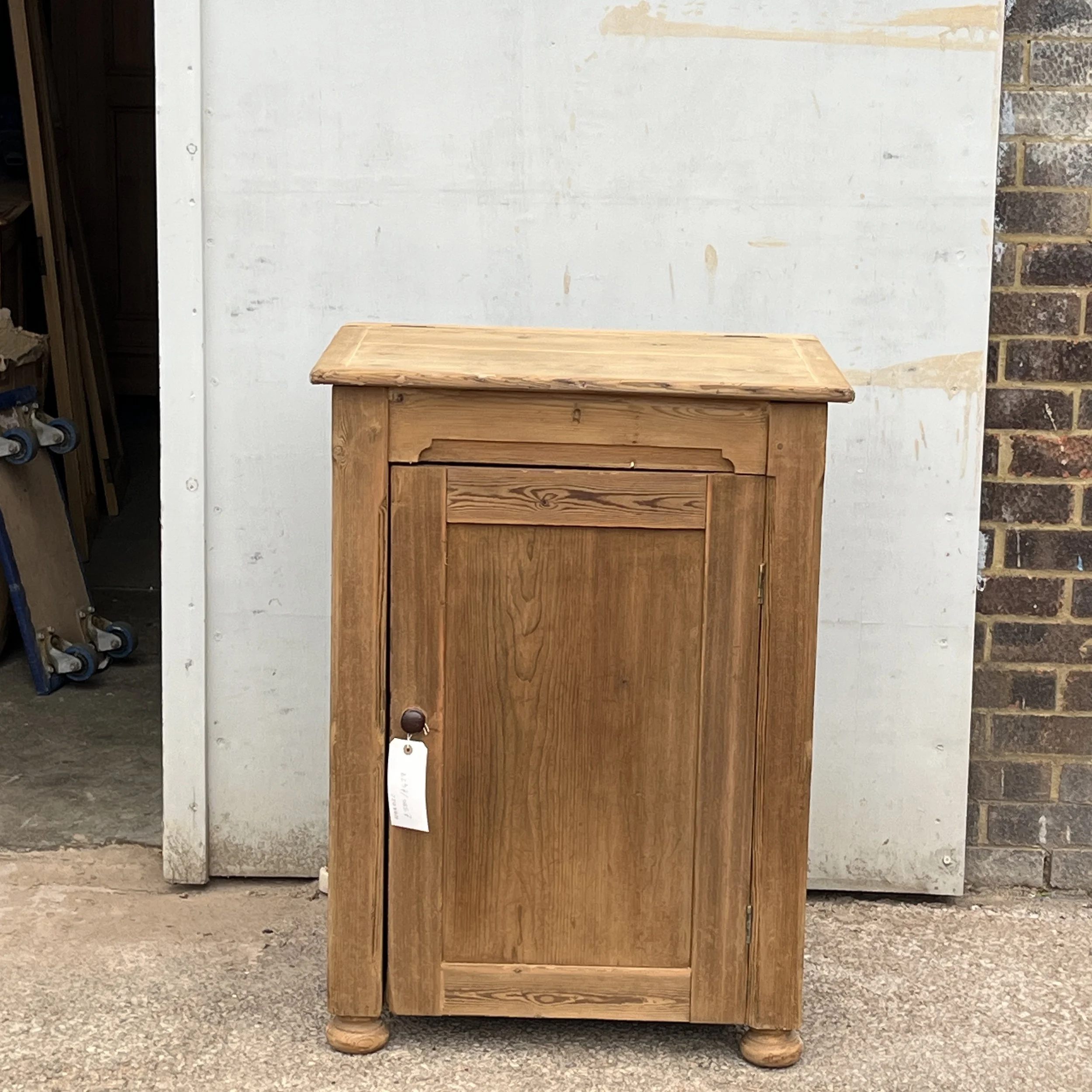 Straight-on front view of pine cupboard N8802C with the top and door closed