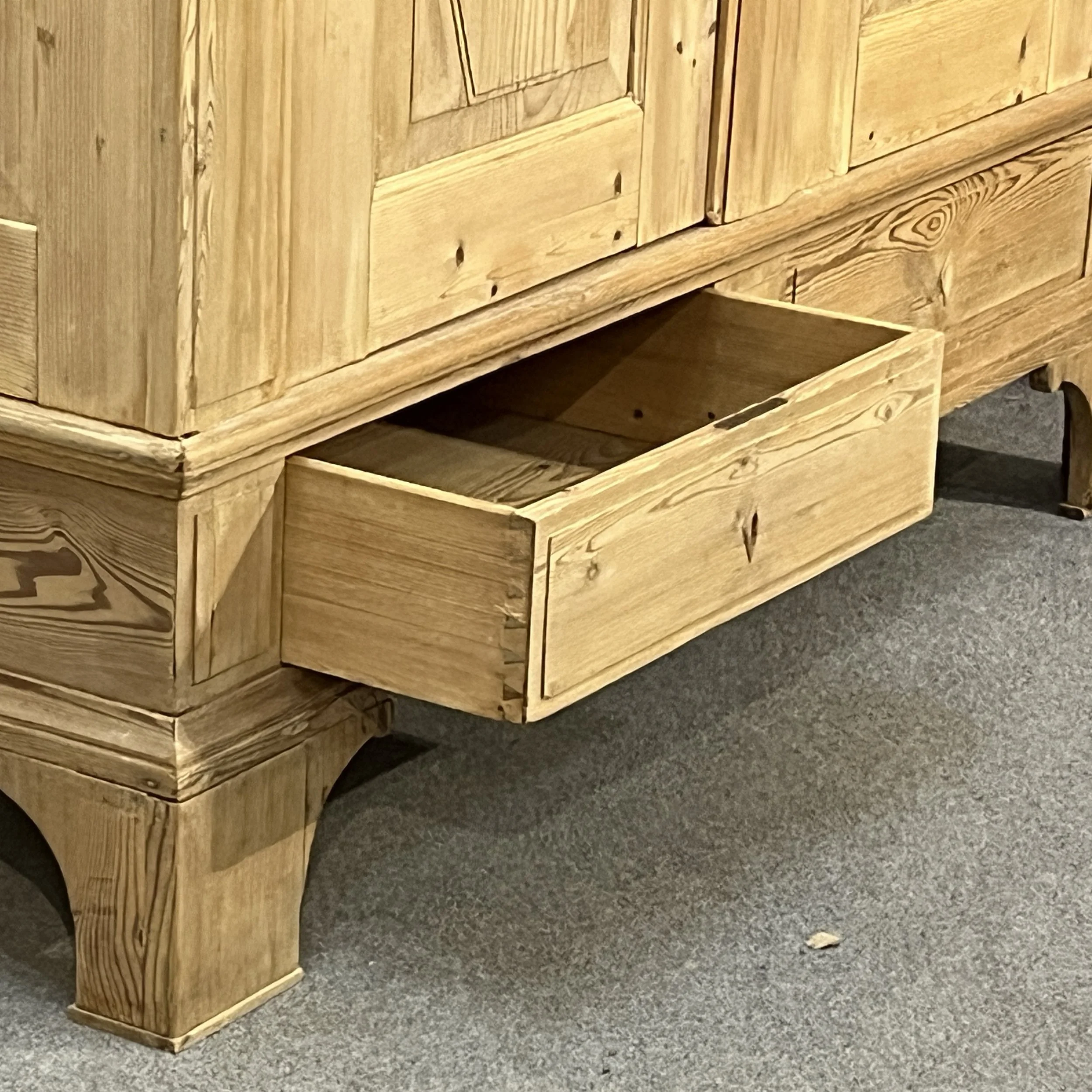Open left base drawer of wardrobe N8206H showing dovetail joints, drawer interior and bracket foot.