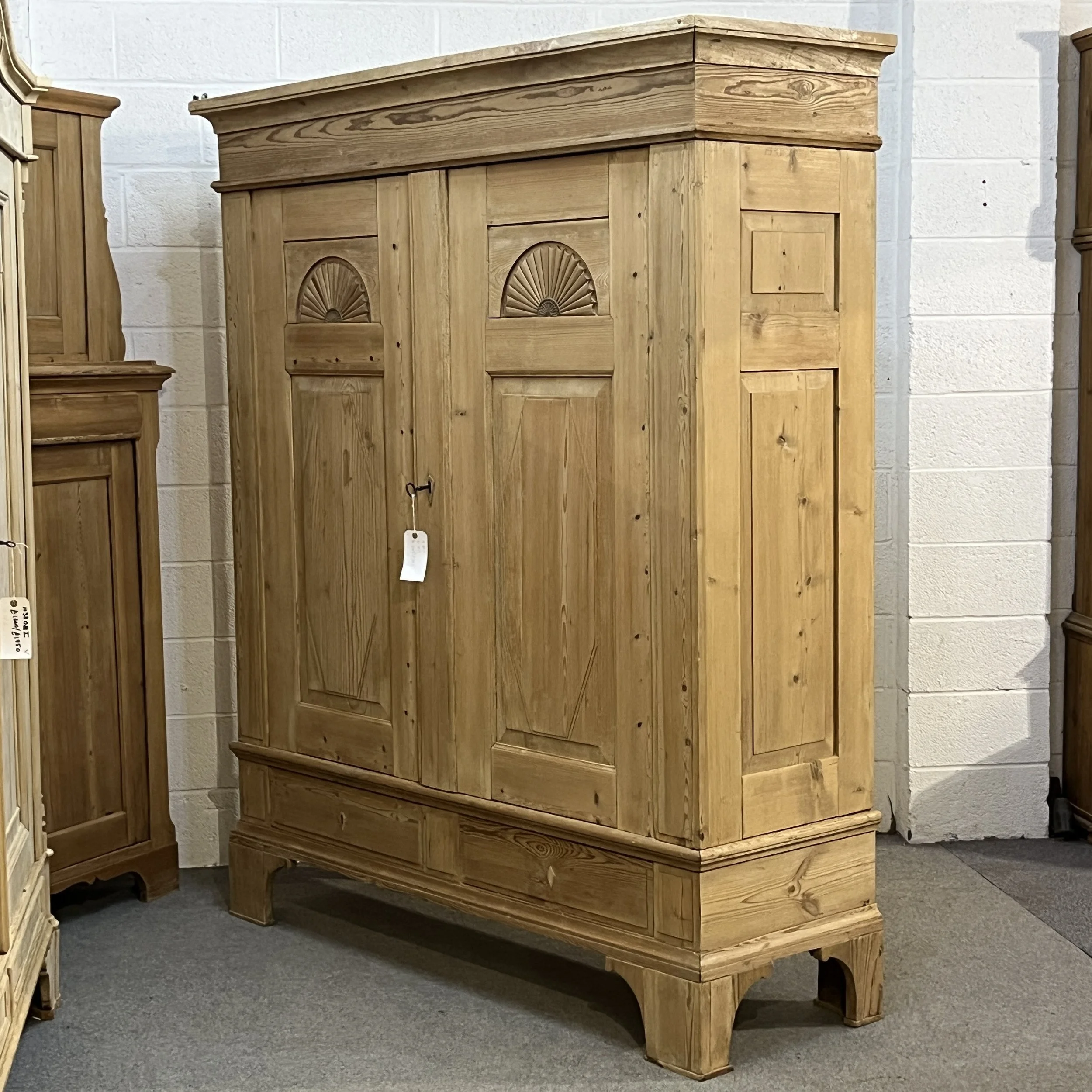 Very large old pine wardrobe N8206H viewed from the right, showing panelled side, cornice and high feet.