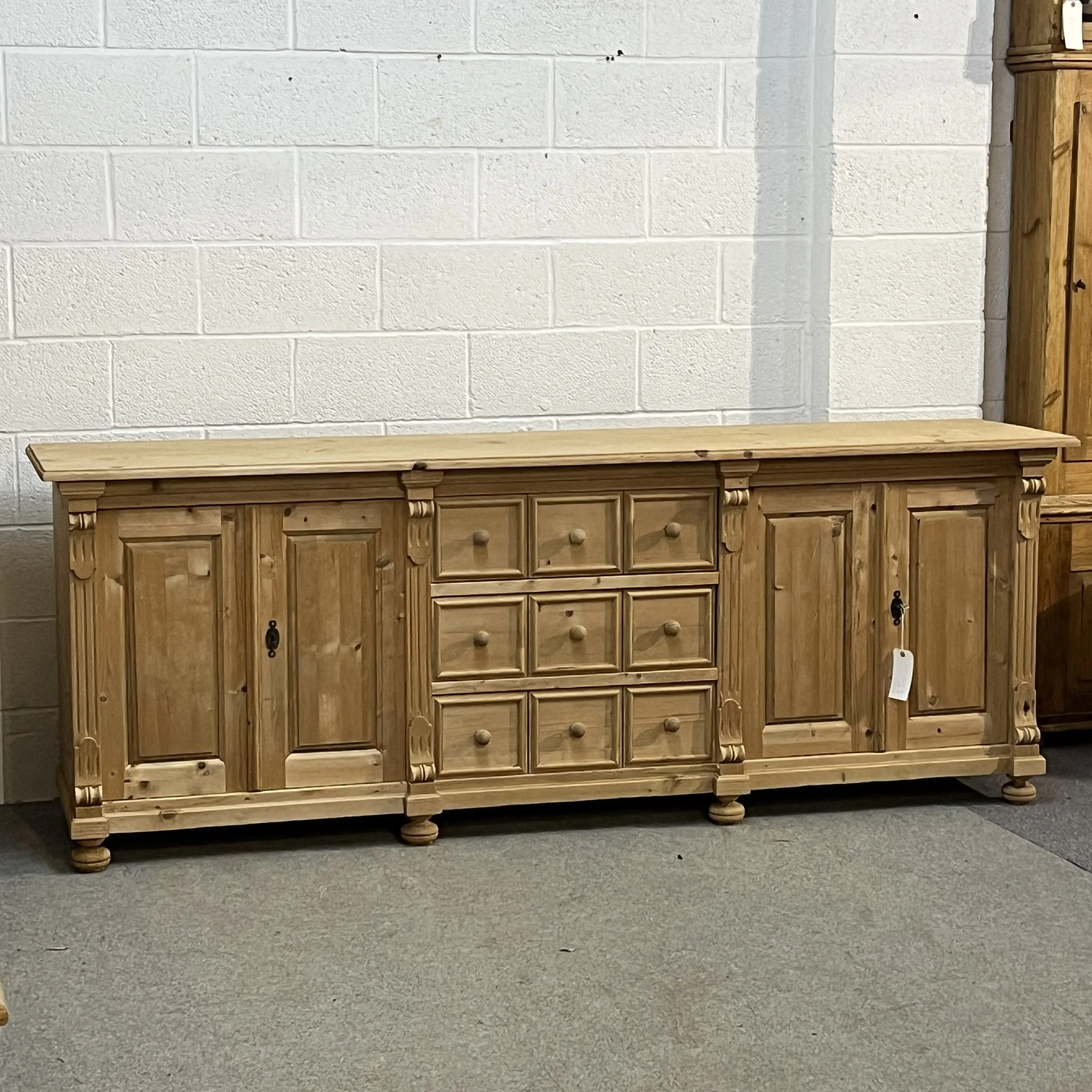 Very large bare pine sideboard N7102E, full front view with four cupboard doors and panelled central drawers