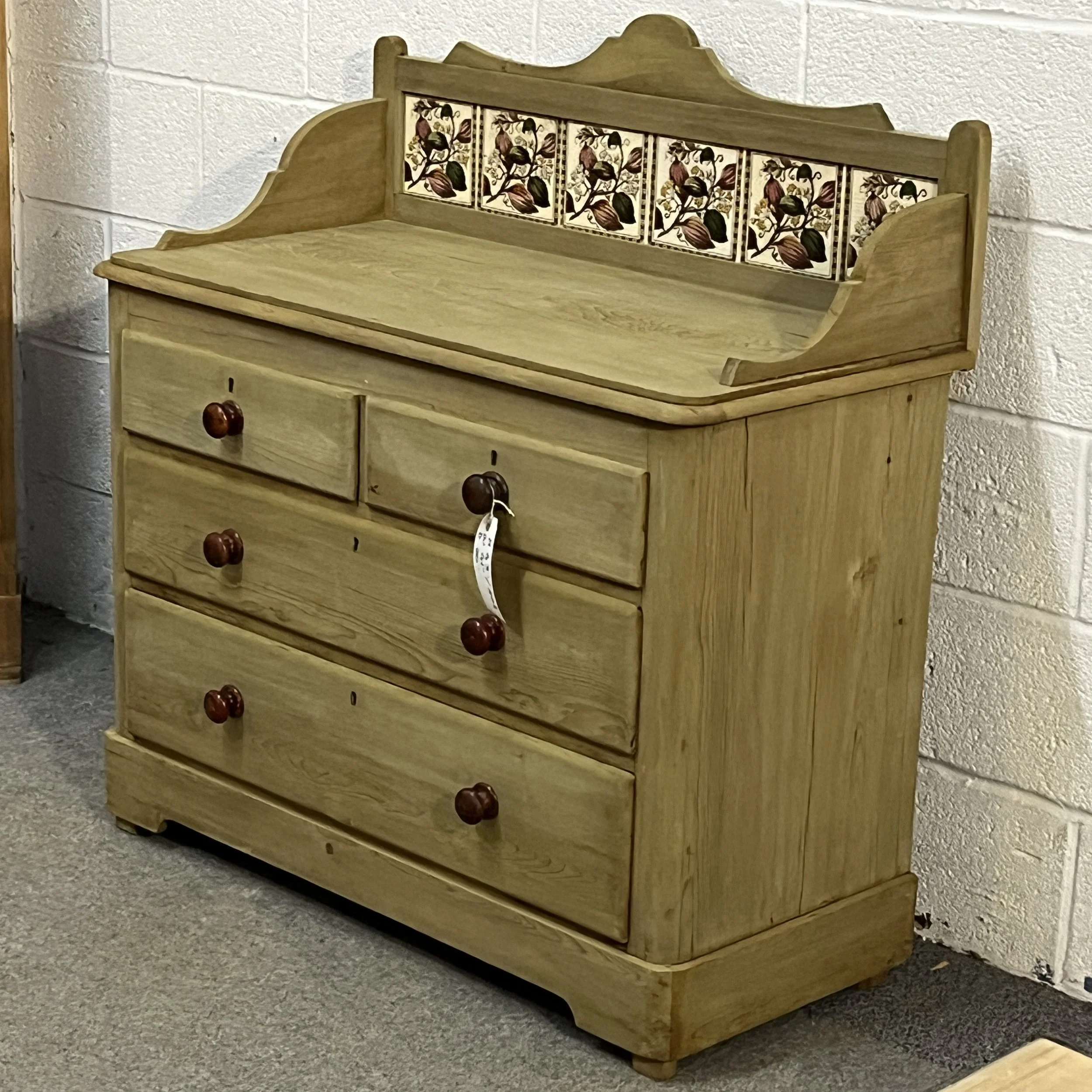 Right three-quarter view of the Victorian pine chest of drawers with tiled splashback
