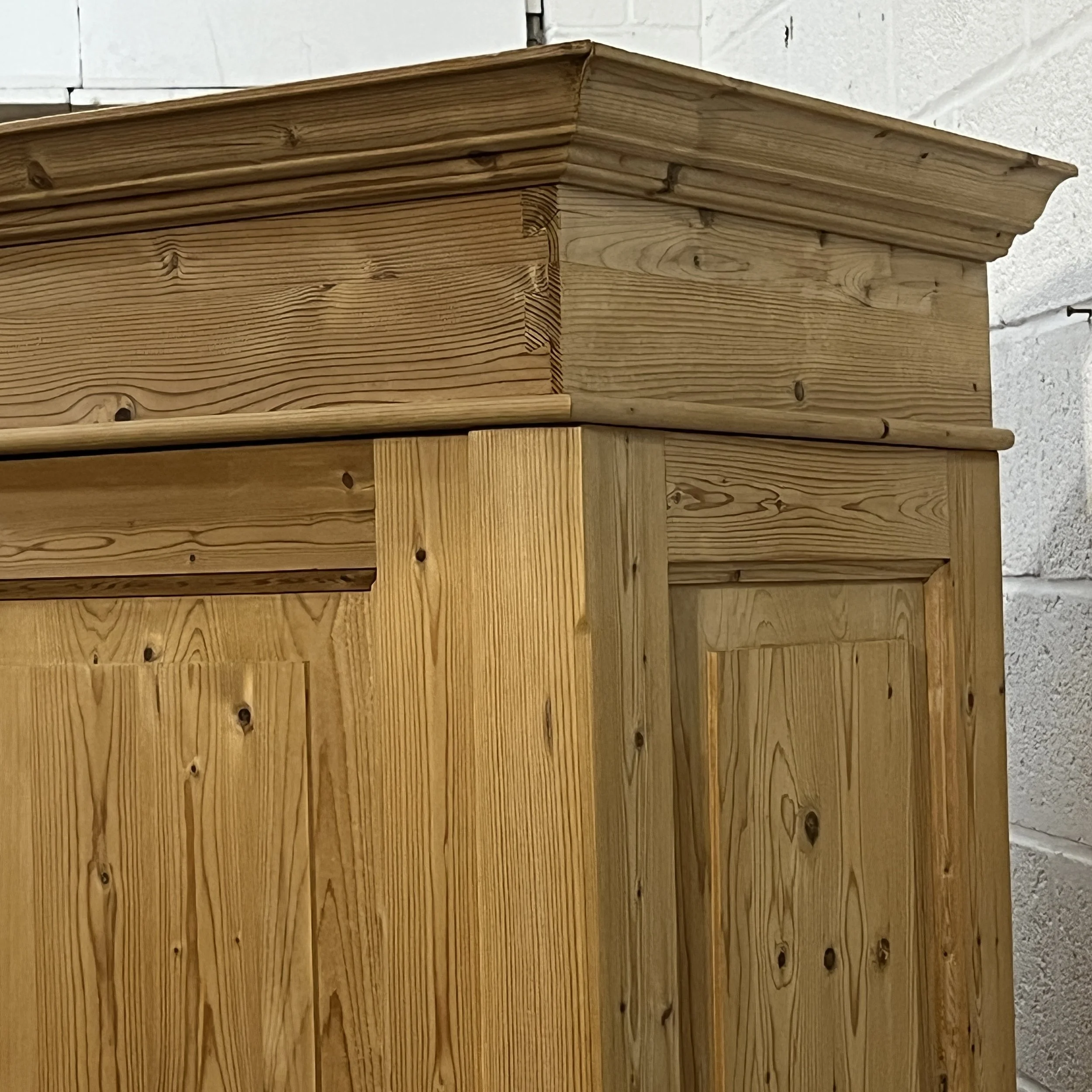 Close view of the pine wardrobe moulded cornice and upper corner