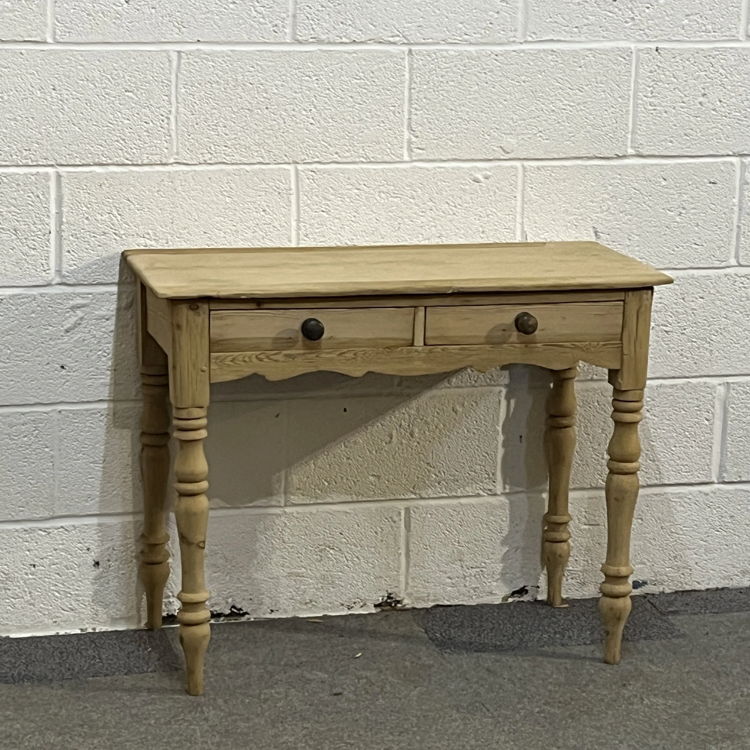 Front view of small Victorian pine dressing table M7506B with two drawers and turned legs