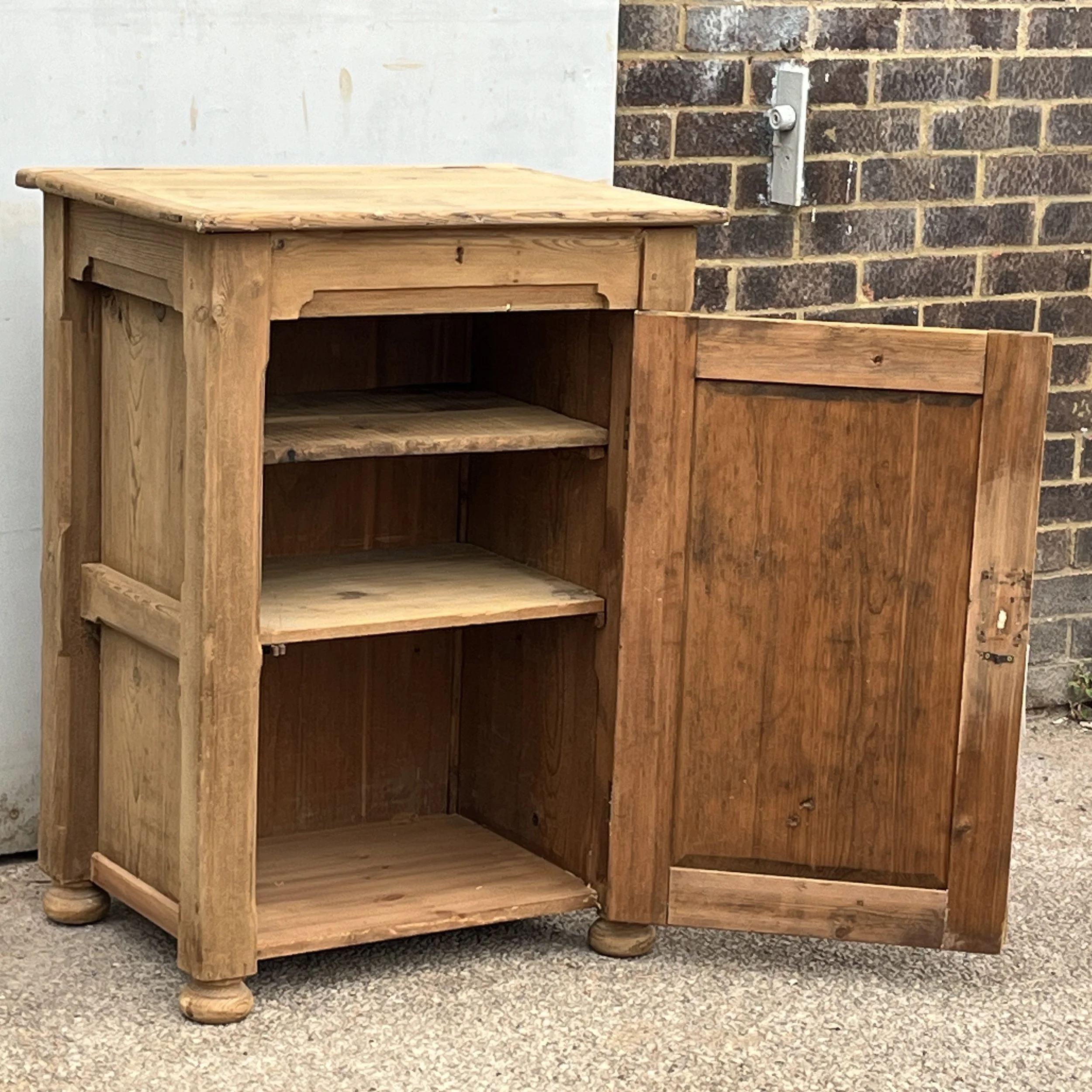 Pine cupboard N8802C with its single door open showing two interior shelves