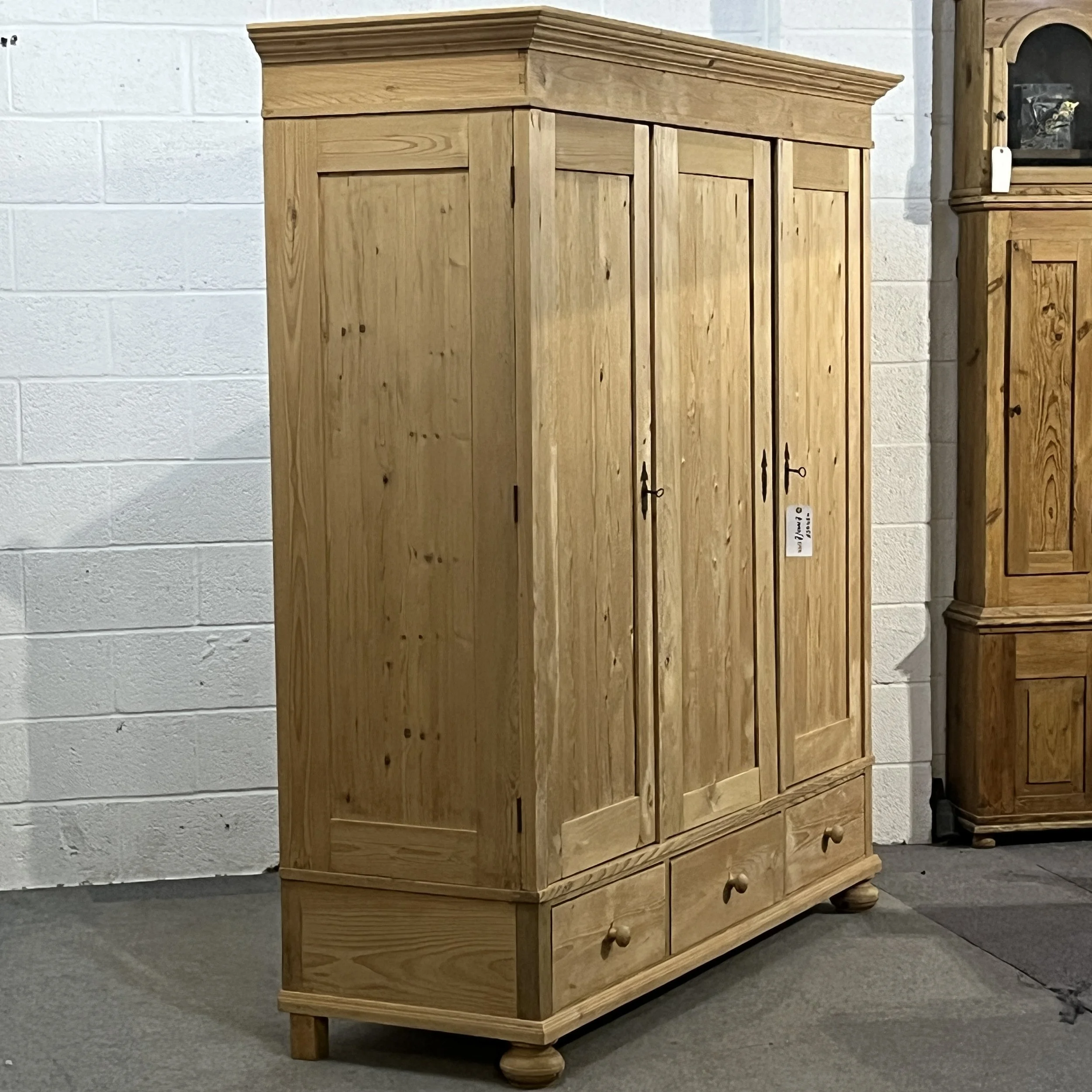 Opposite angled view of the triple pine wardrobe showing its left side