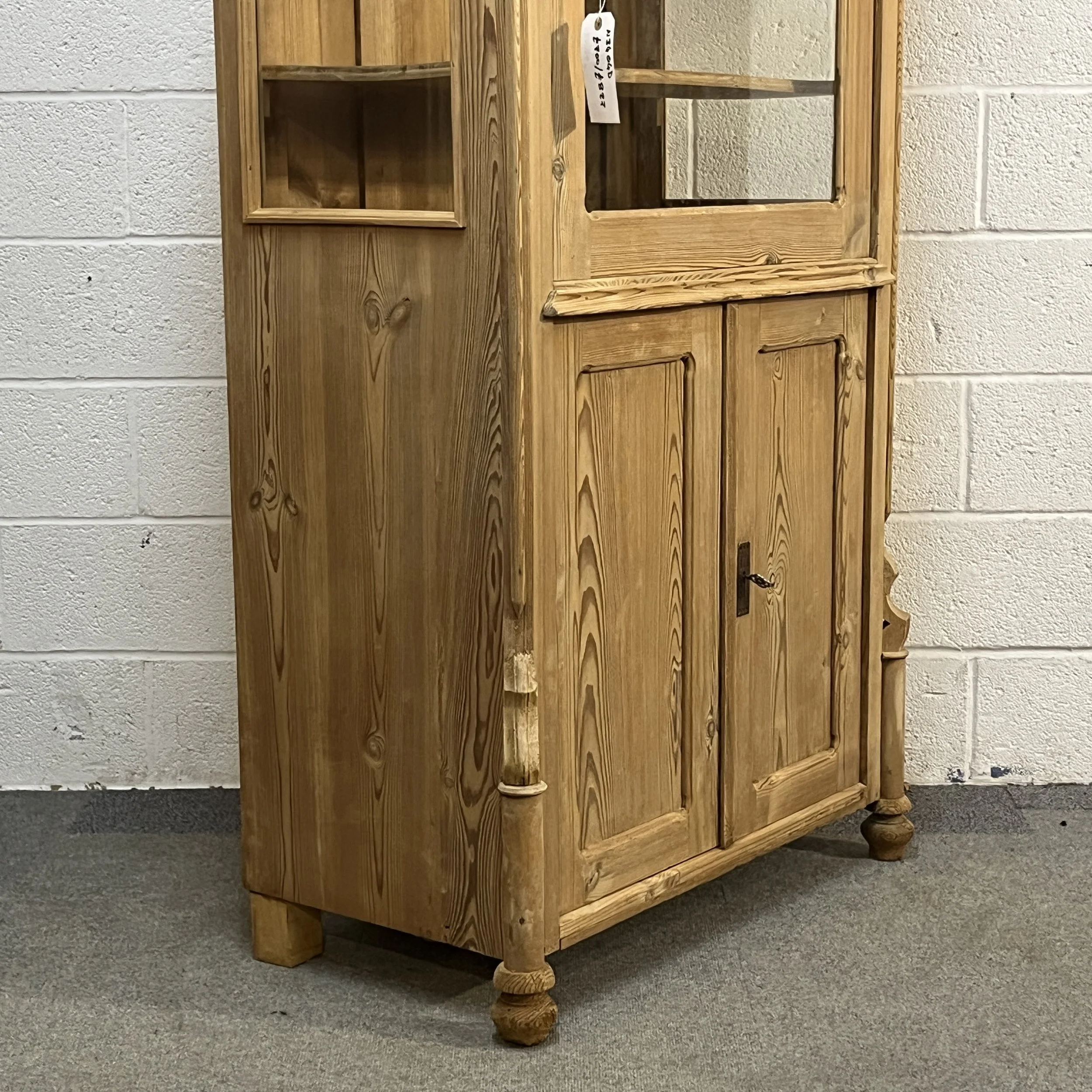 Lower panelled doors, decorative column and turned feet of antique pine cabinet N3404D