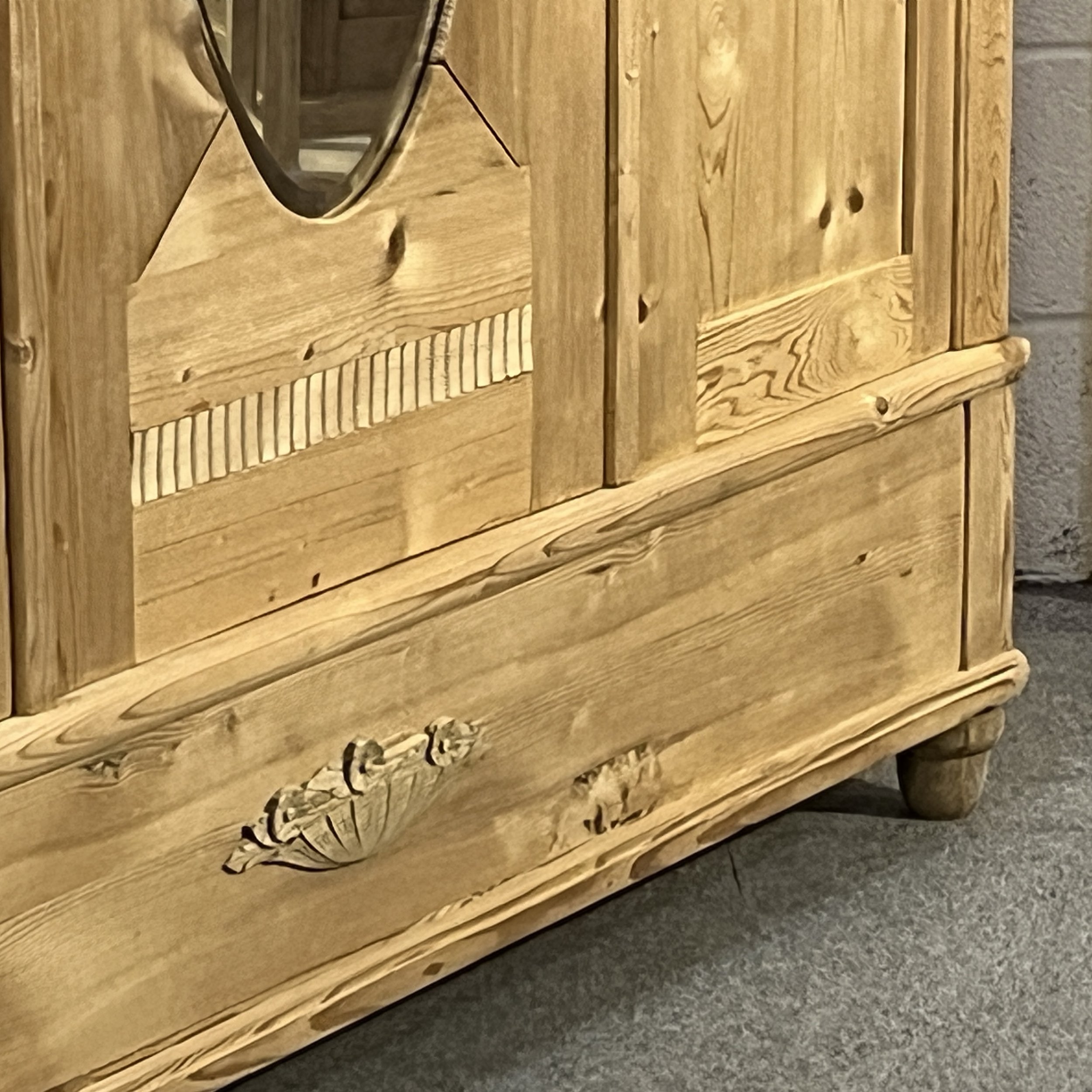 Close view of the pine wardrobe bottom drawer and decorative metal handle