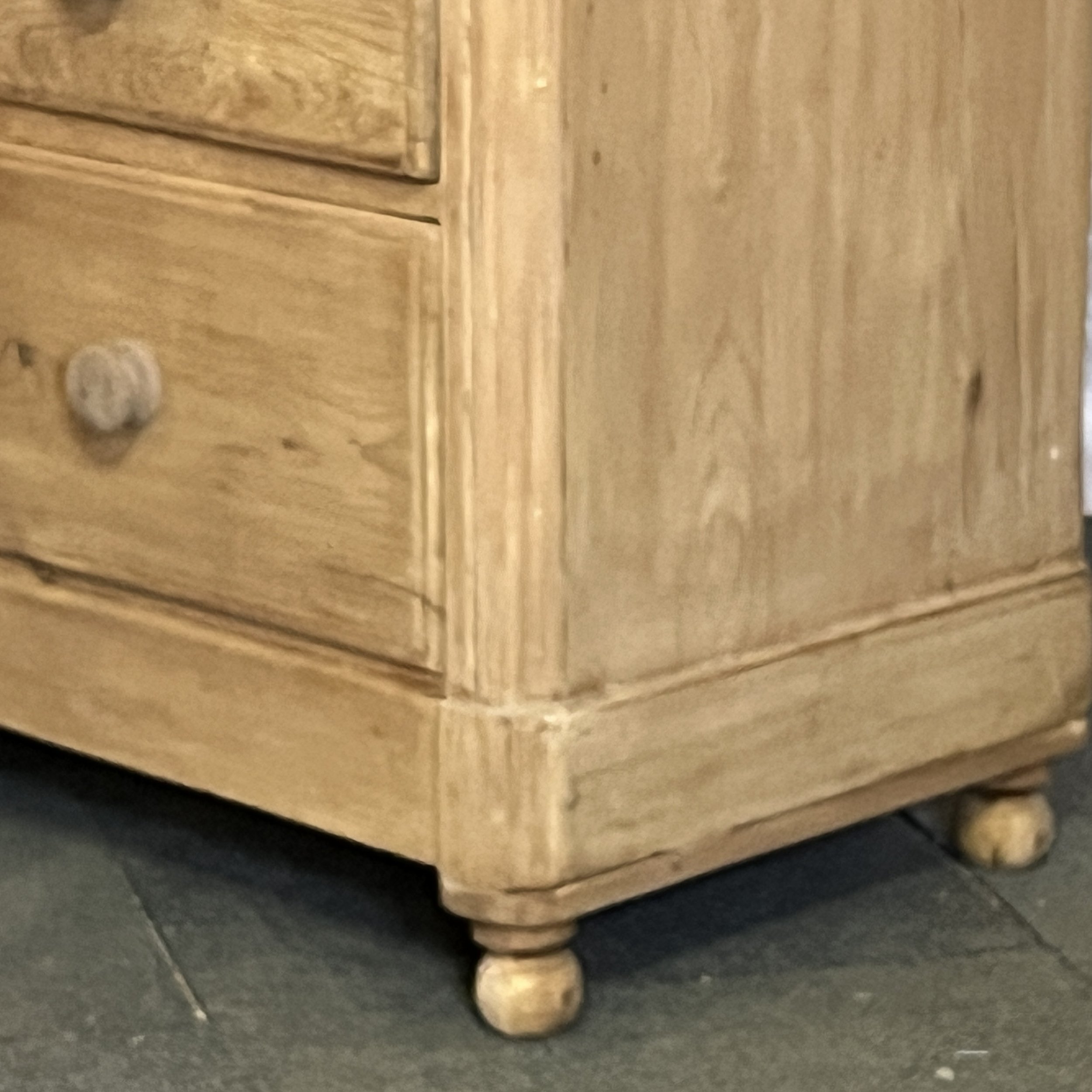 N4852E pine chest lower corner showing base moulding, side panel and turned bun foot