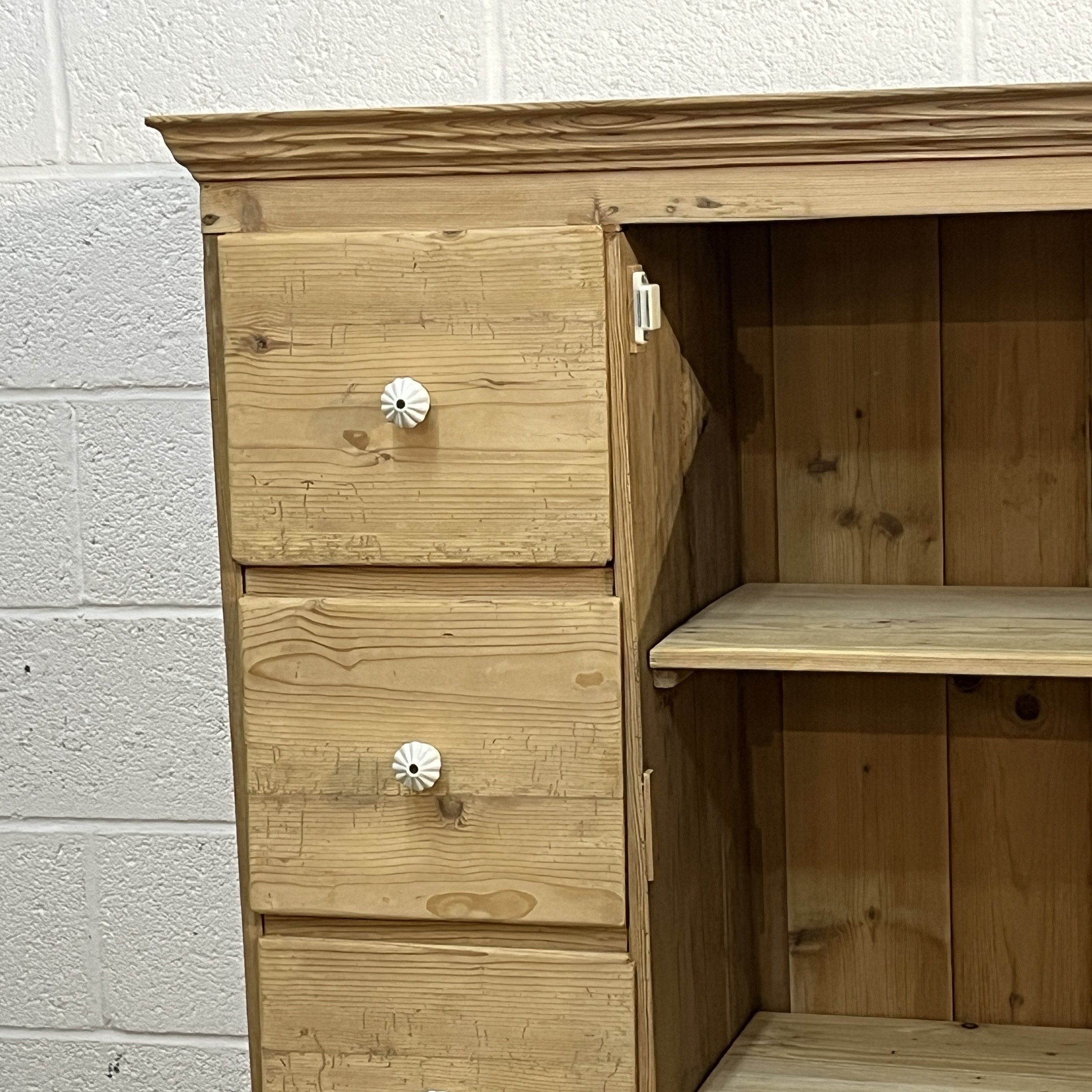 Detail of upper drawers, ceramic knobs and magnetic catch on pine cupboard N7408C