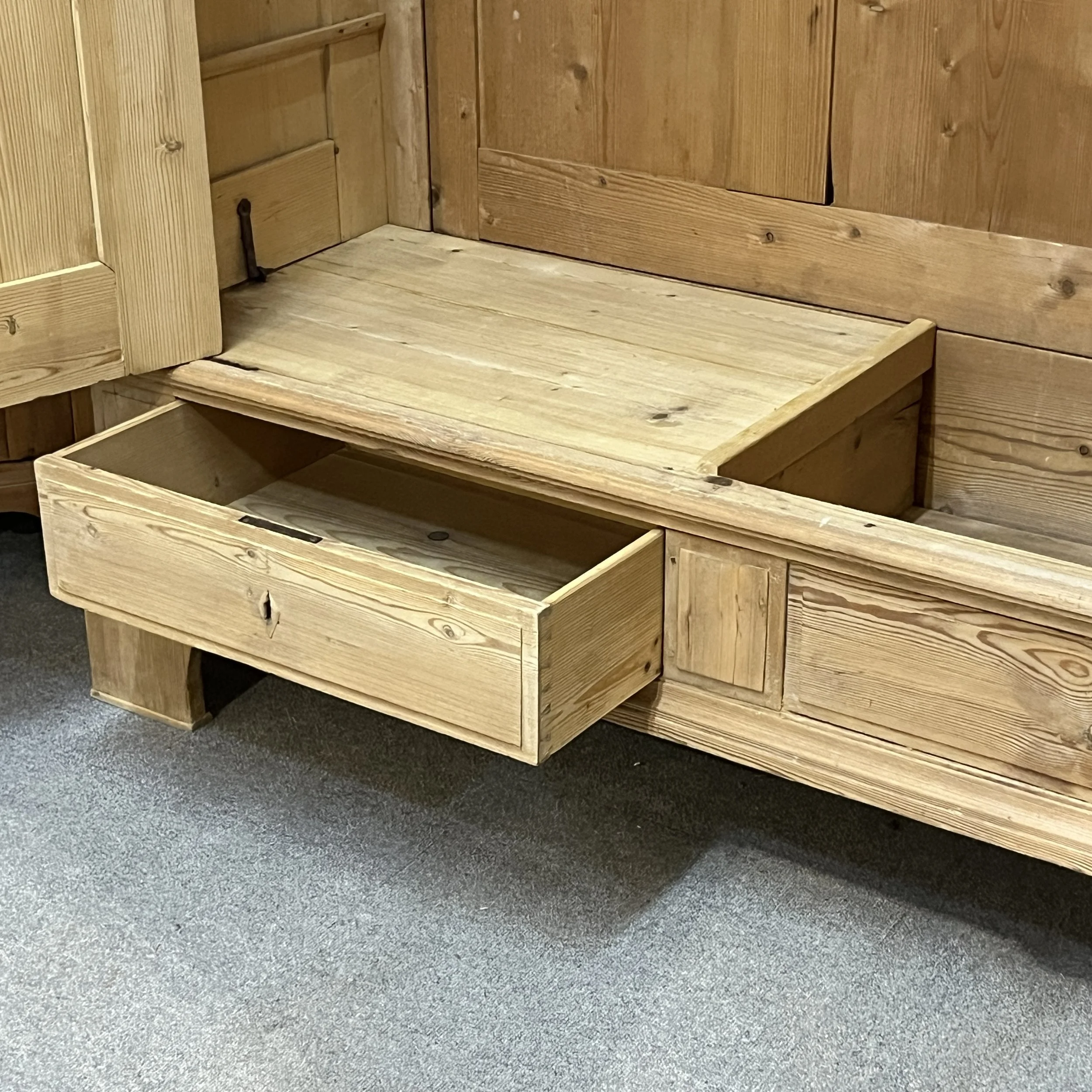 N8206H wardrobe with its left base drawer open, showing the drawer compartment and interior base.