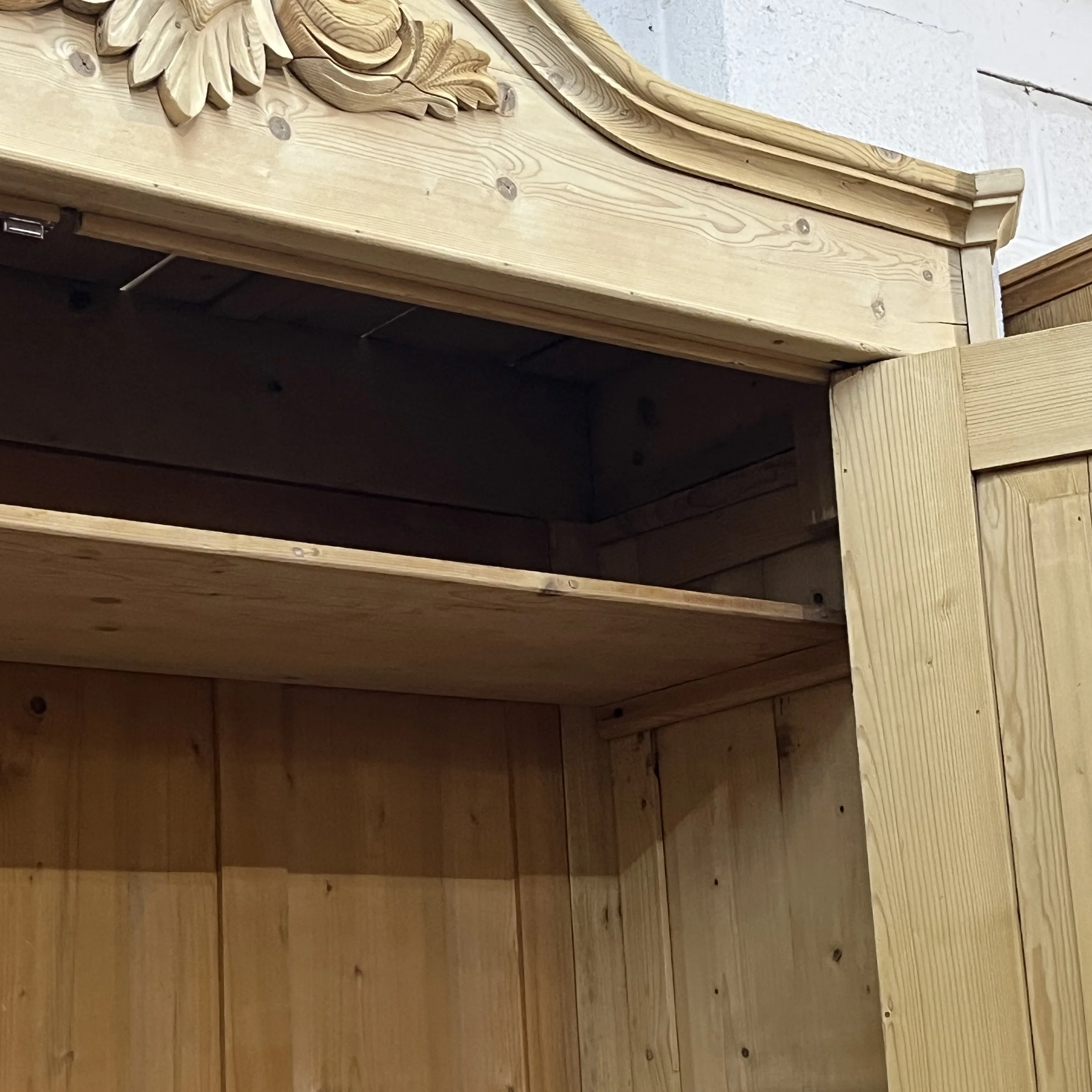 Close view of the pine wardrobe upper interior shelf and open door