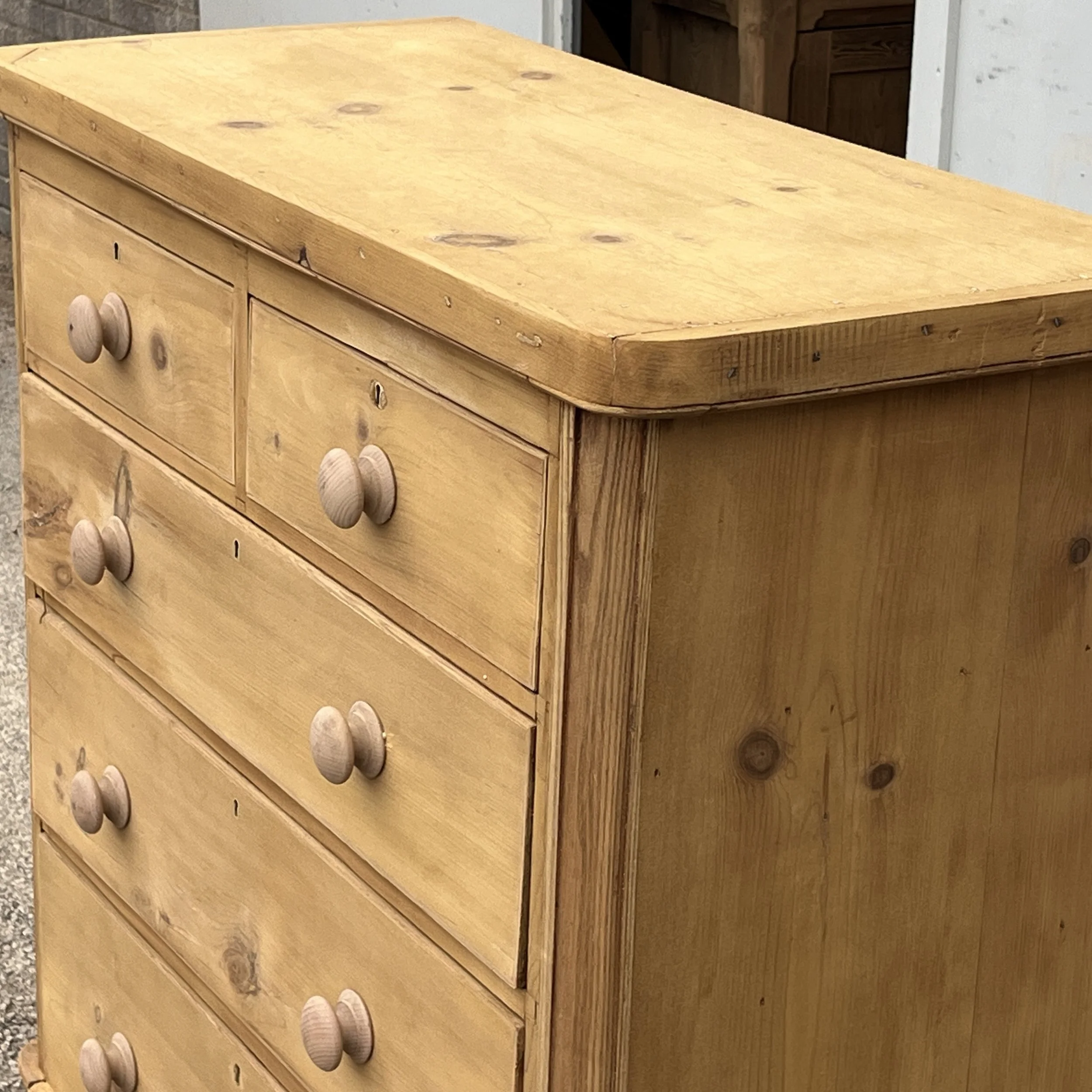 Detail of the top, wooden knobs and moulded front corner of pine chest N8709E