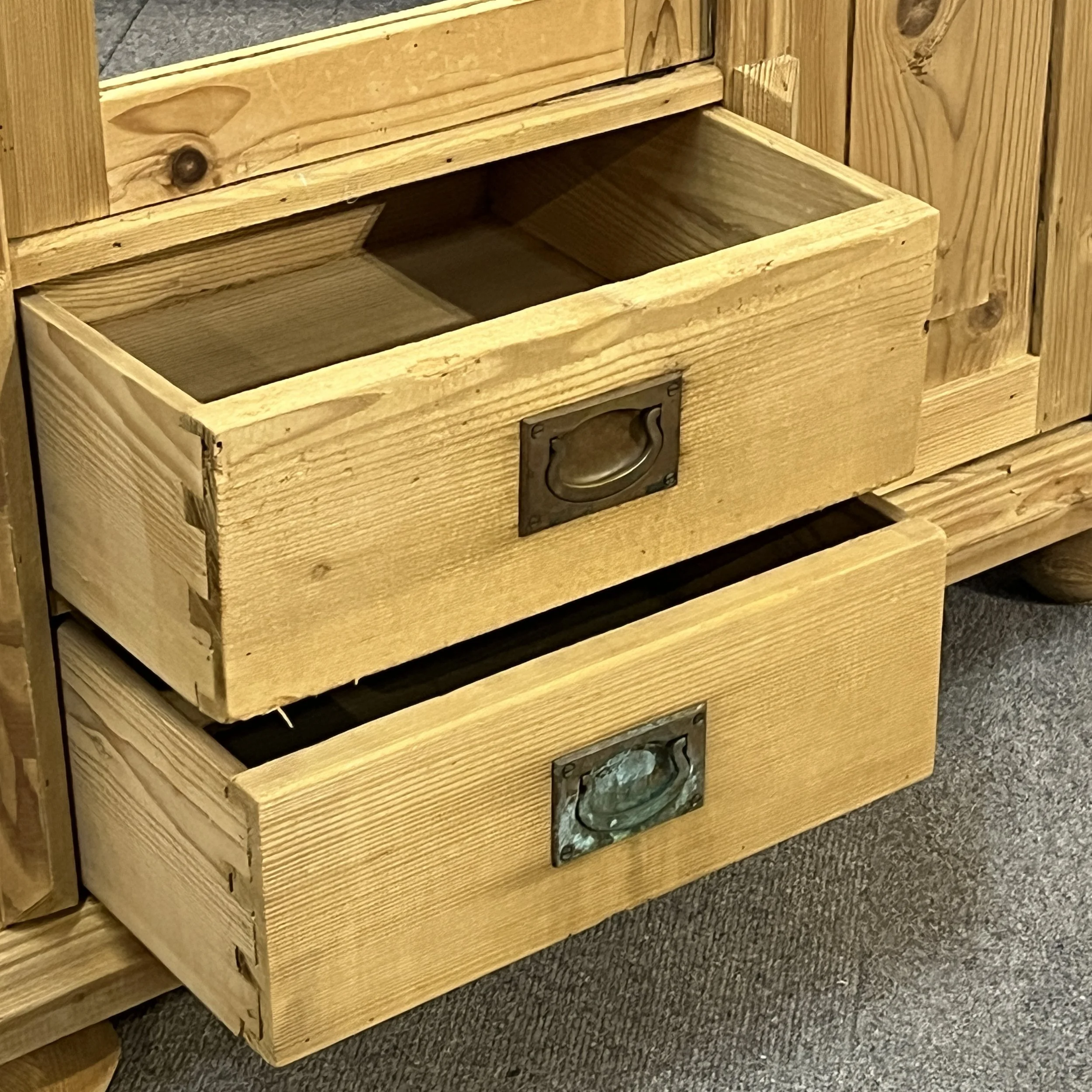 Close-up of two dovetailed drawers and recessed aged metal handles on pine cabinet N7500D