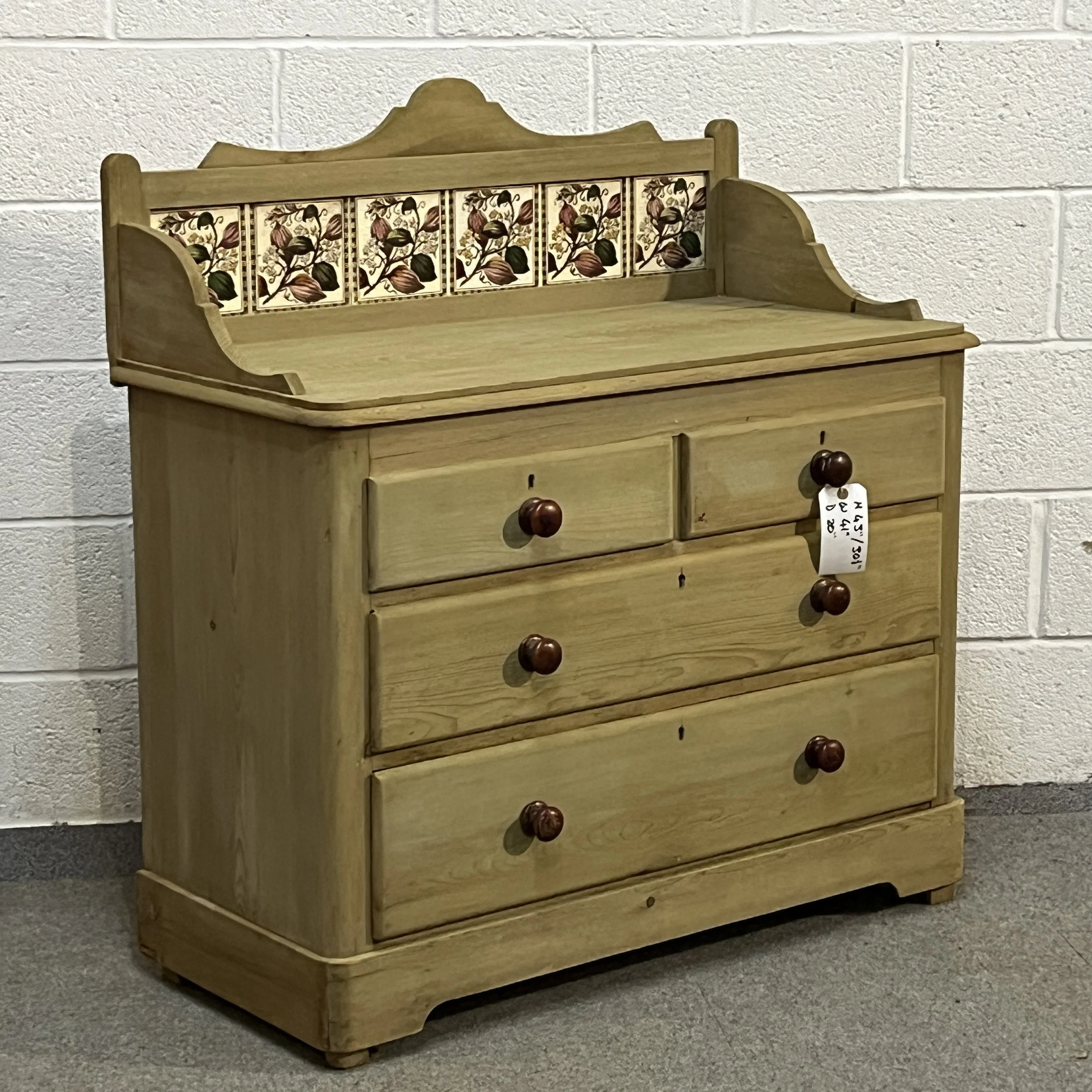 Left three-quarter view of the Victorian pine chest of drawers with tiled splashback