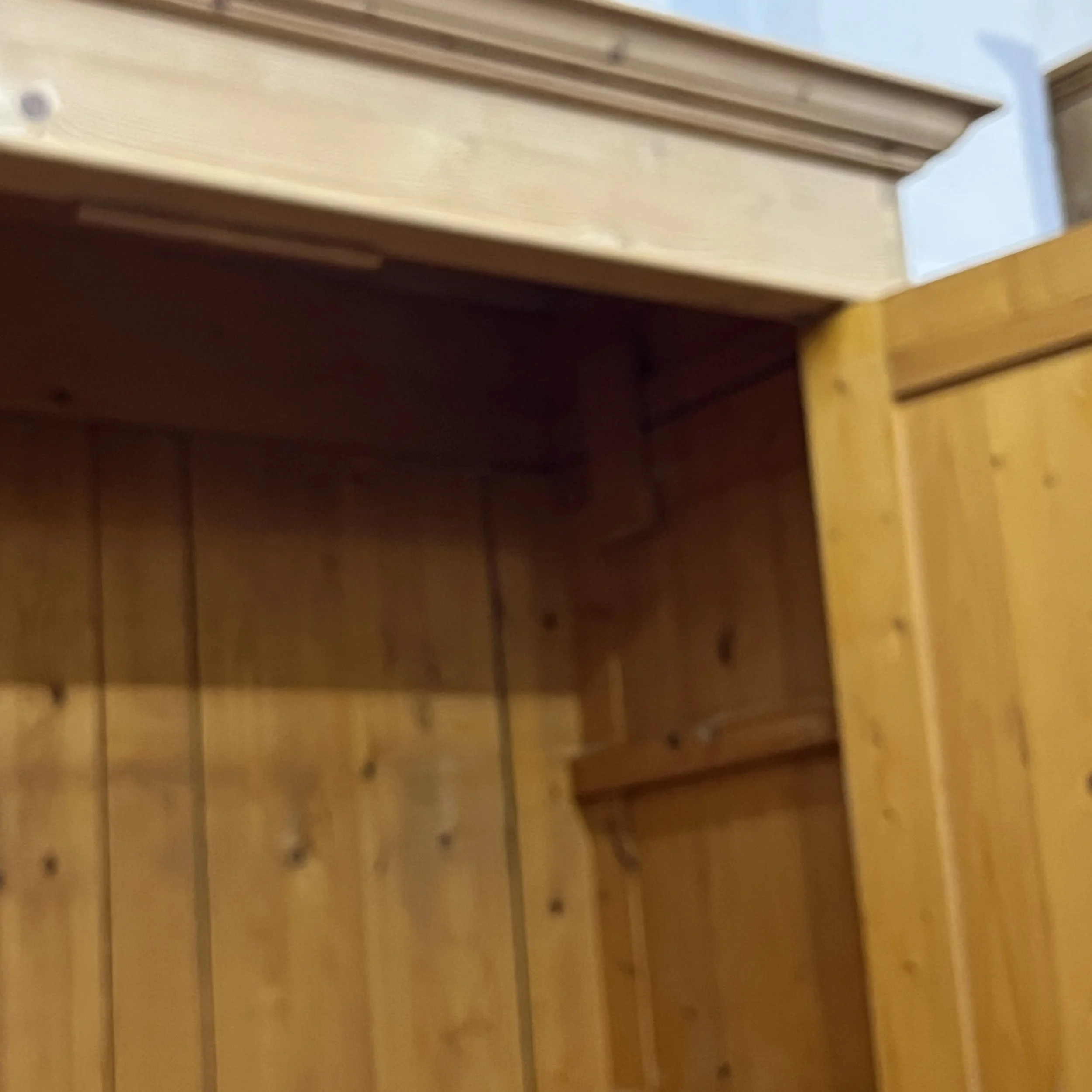 Detail of the pine wardrobe upper interior beneath the cornice