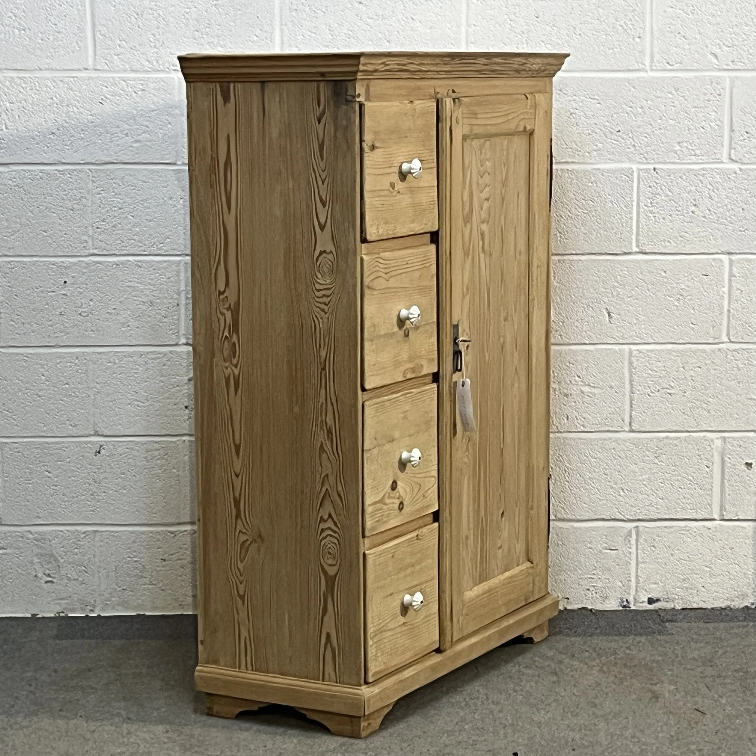 Left-hand angled view of antique pine larder cupboard N7408C with four drawers