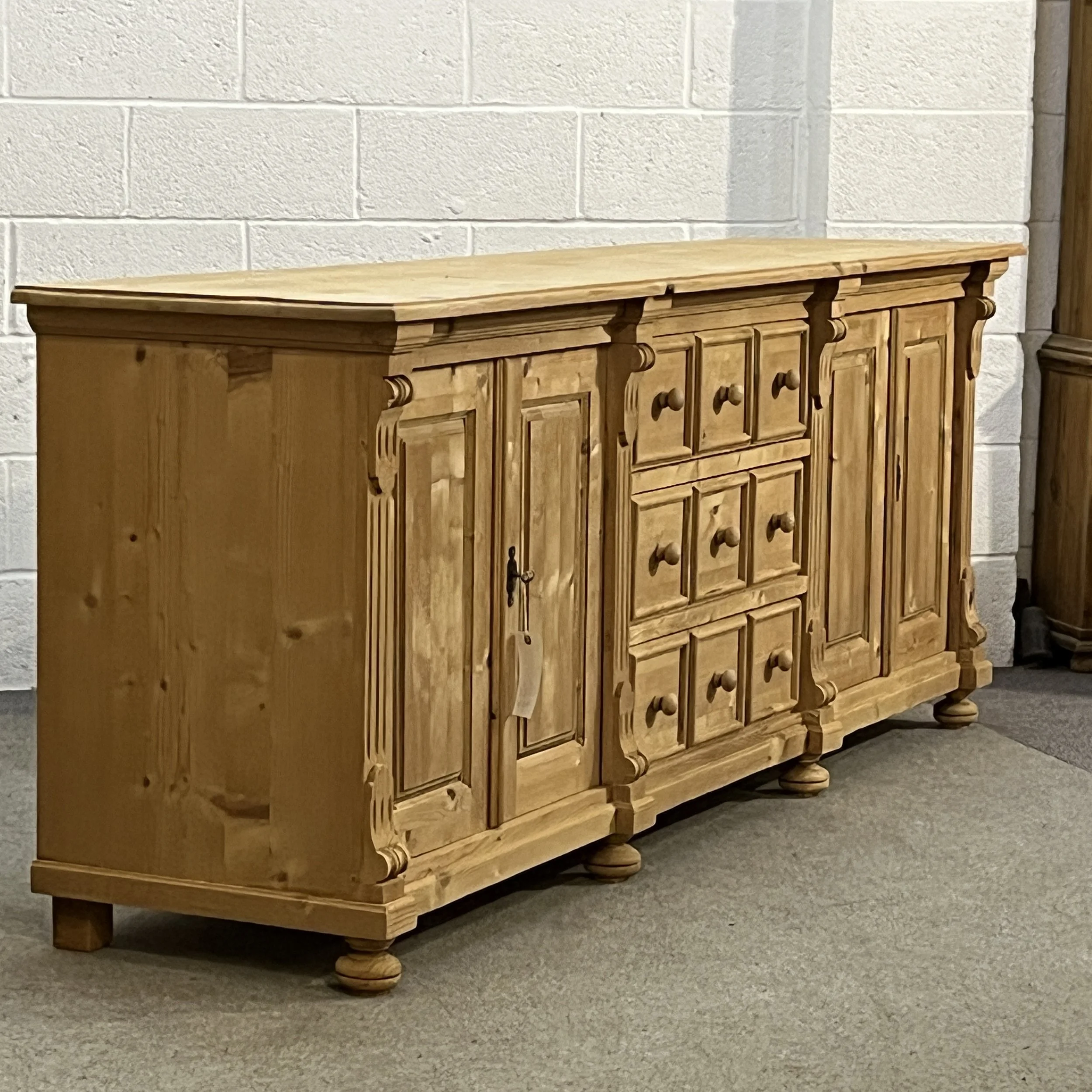 Left angled full view of pine sideboard N7102E showing the solid side panel and turned feet