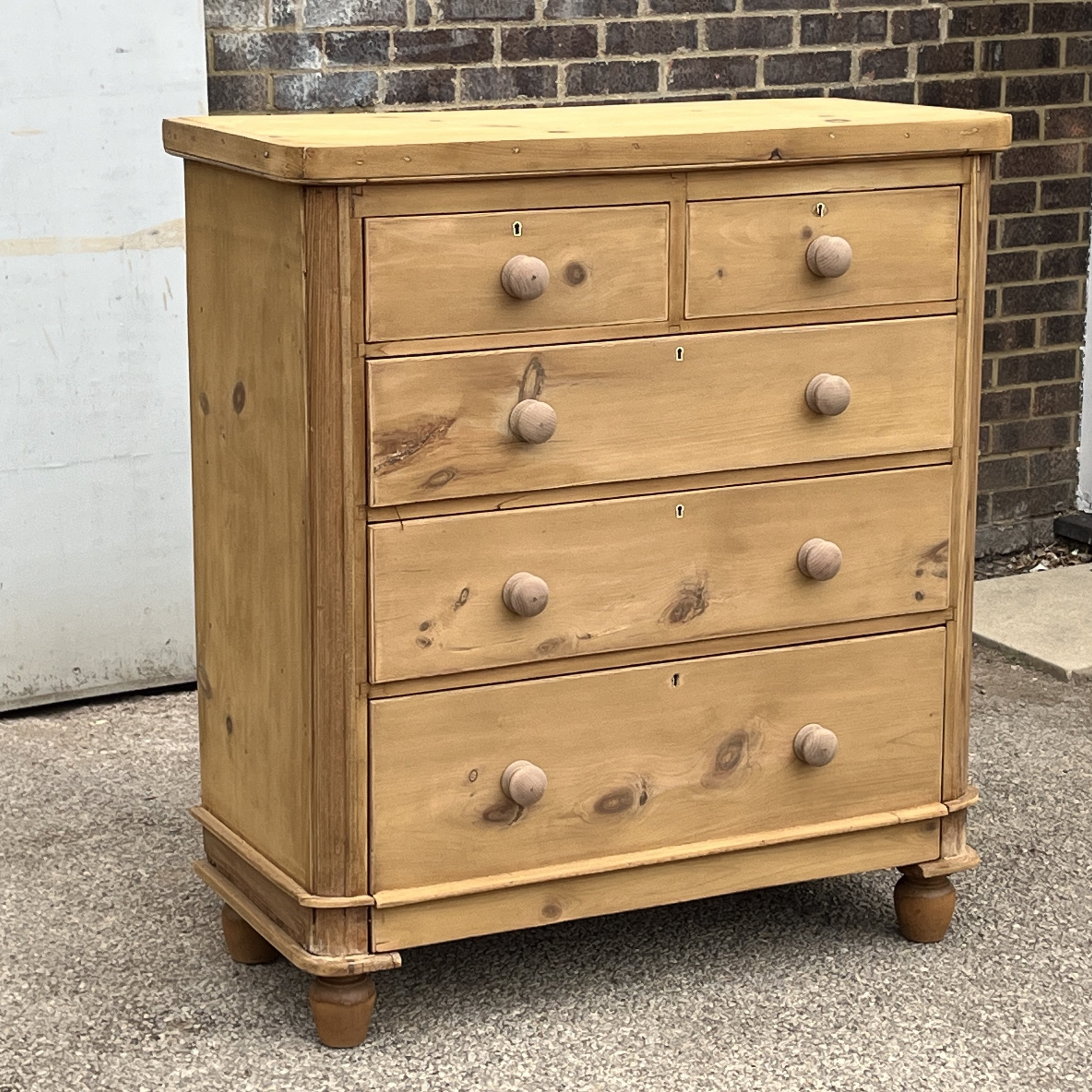 Left-side angle of Victorian pine chest N8709E showing wooden knobs and turned feet