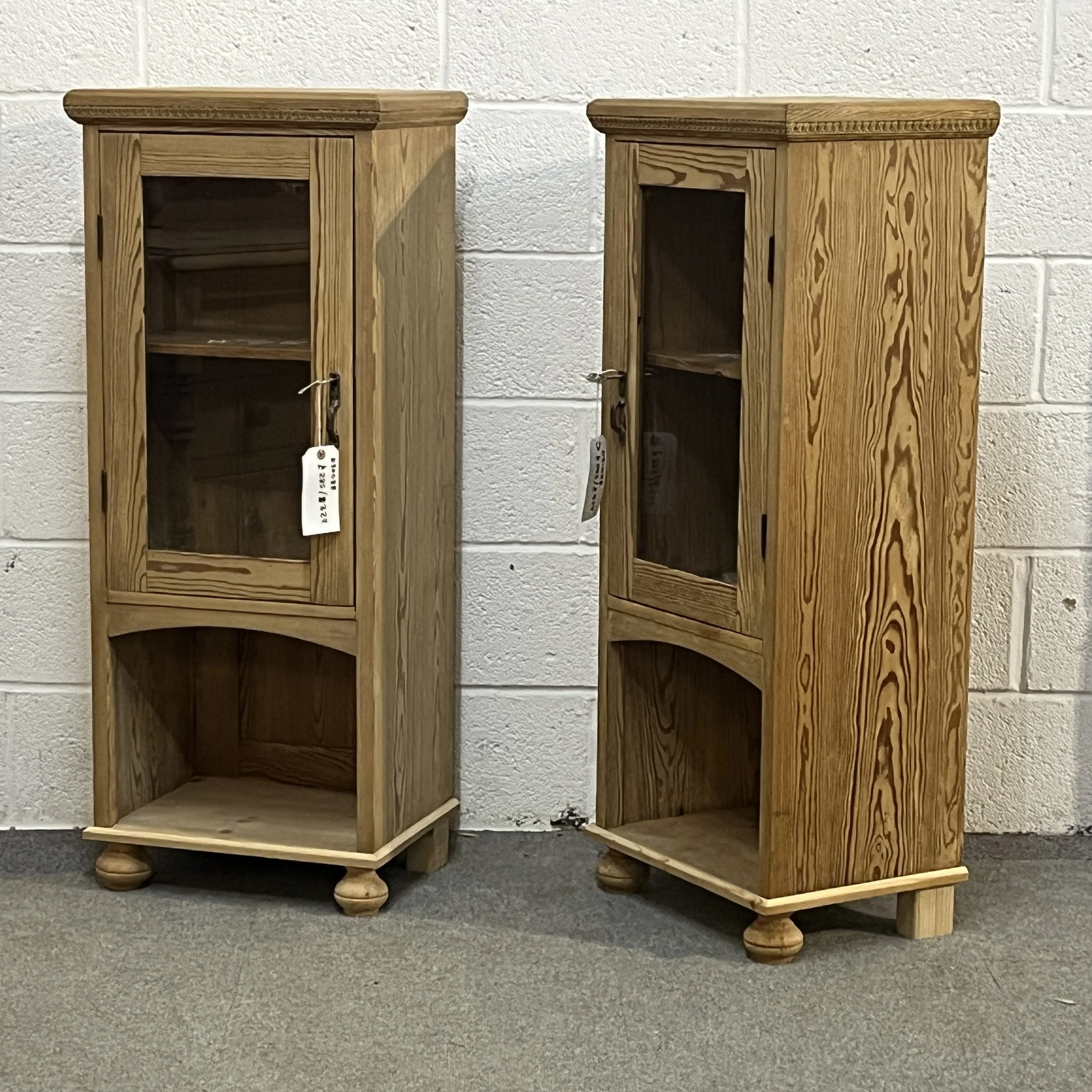 Angled view of the pair of pine glazed cabinets showing their right sides