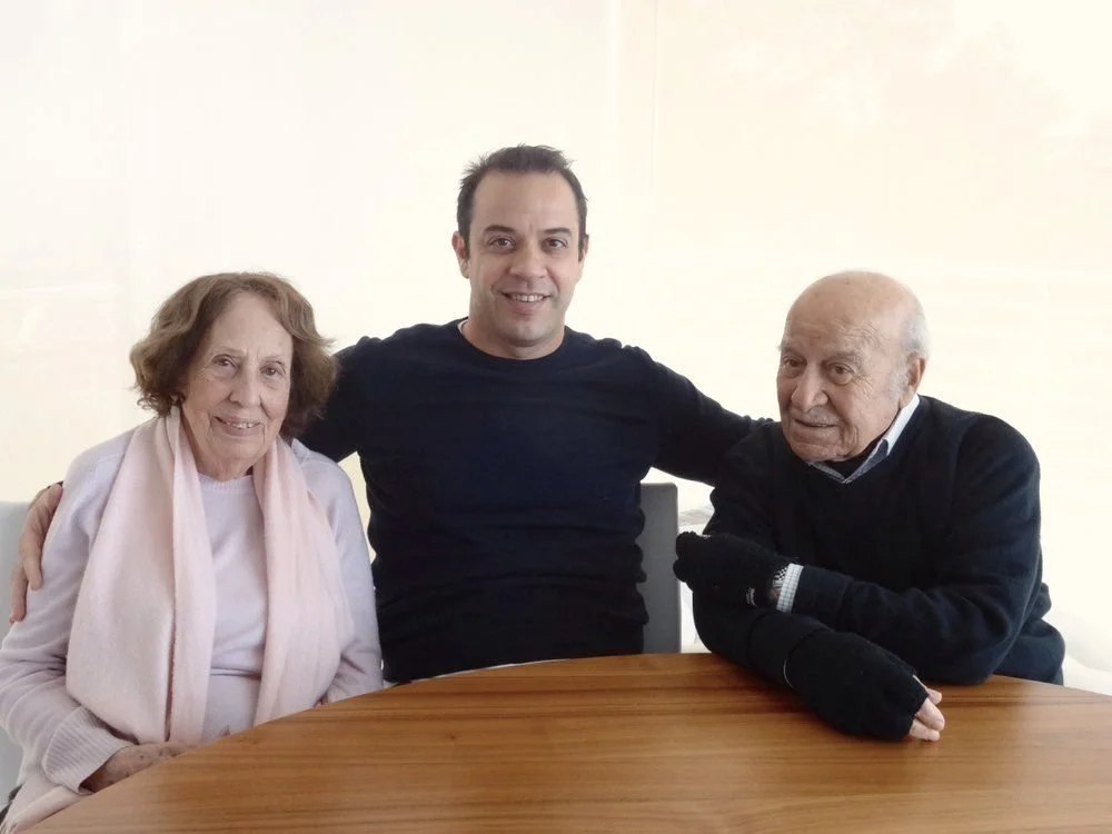 Simon Fiorini Lowell sitting at a table with his grandparents.