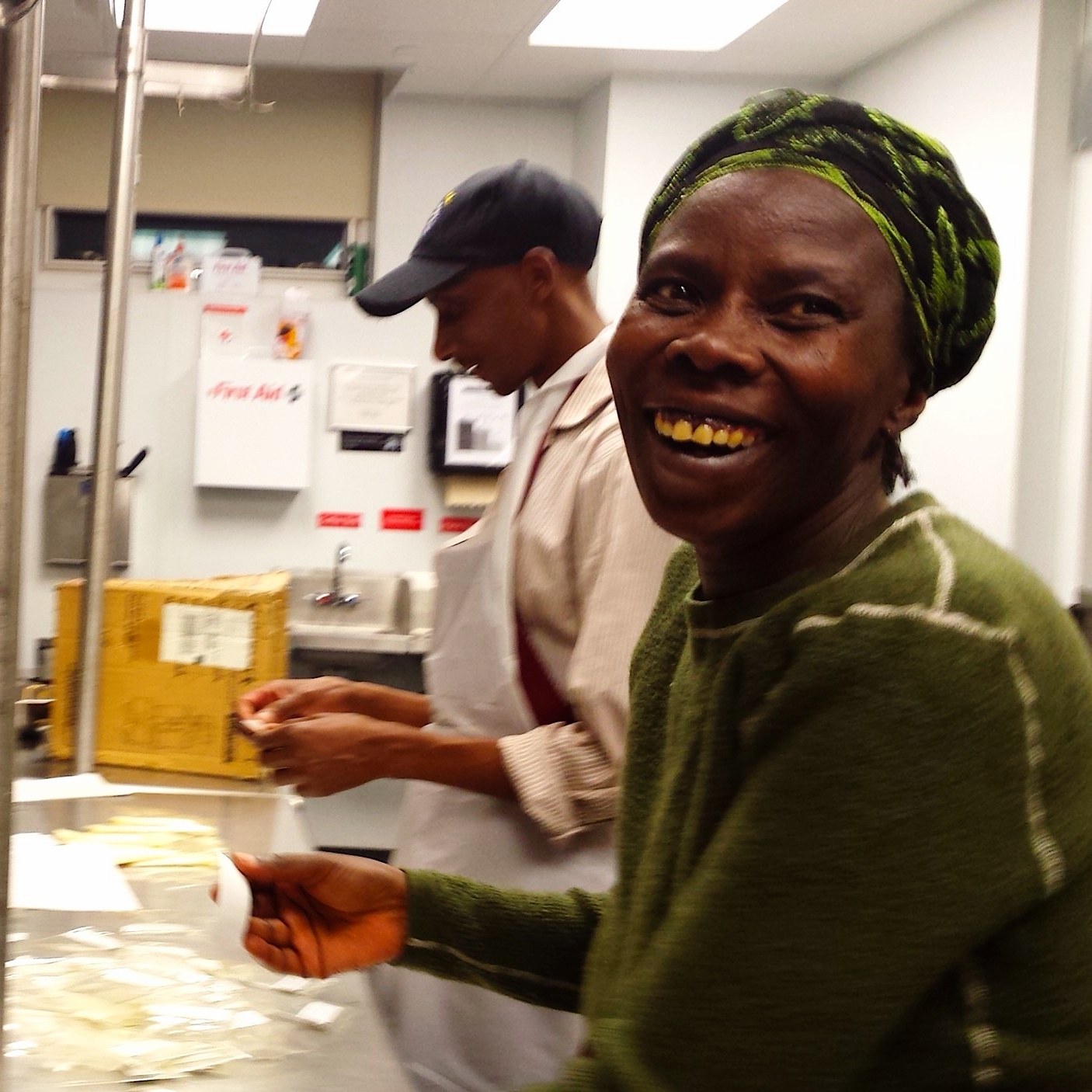 Faranswazi smiles while labeling with Nzitonda and Murekatete.jpg