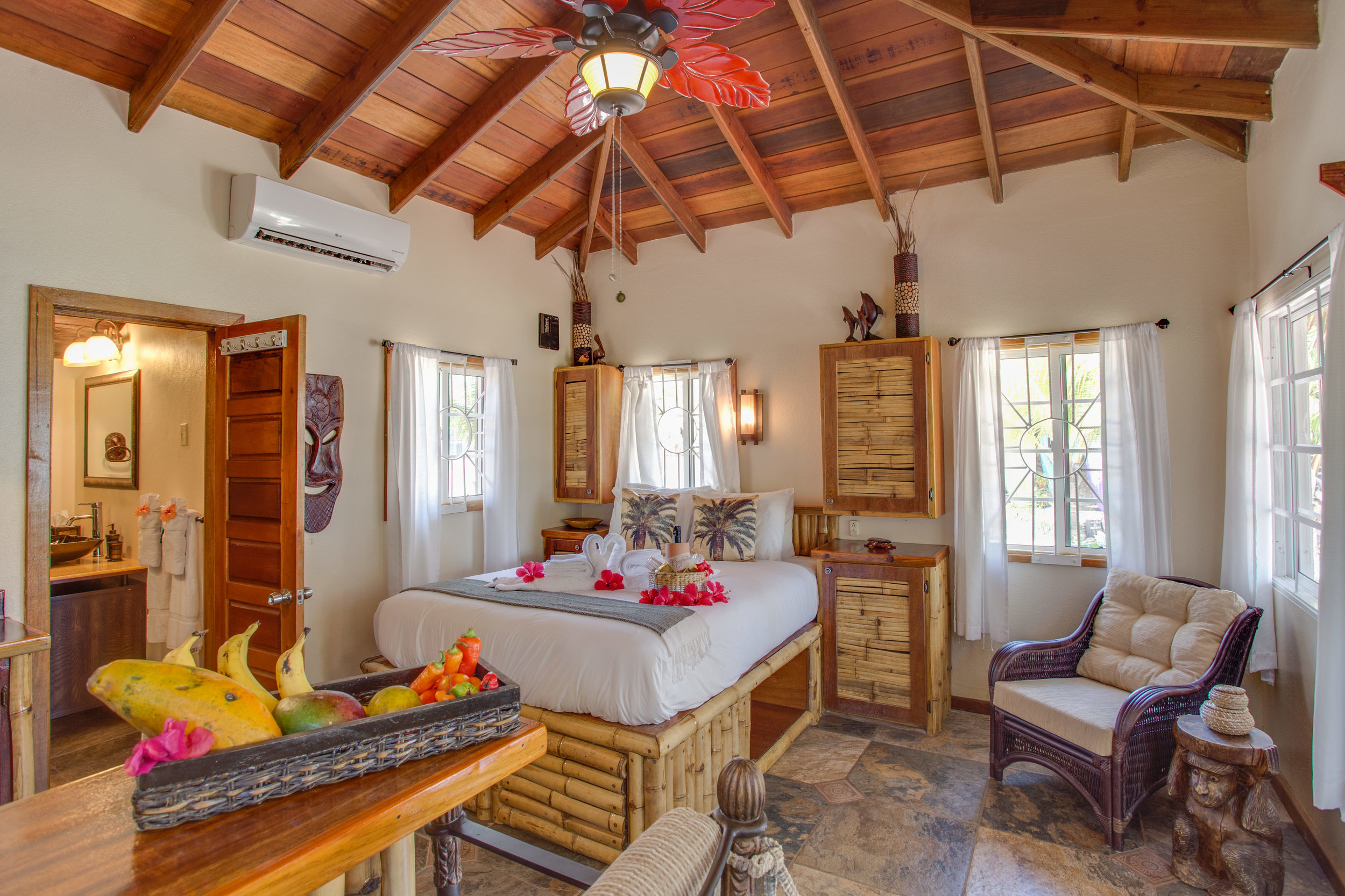 These traditional Belizean cabanas have luxury bedding, Belizean wood ceiling, bamboo accents, with exotic furniture and local art