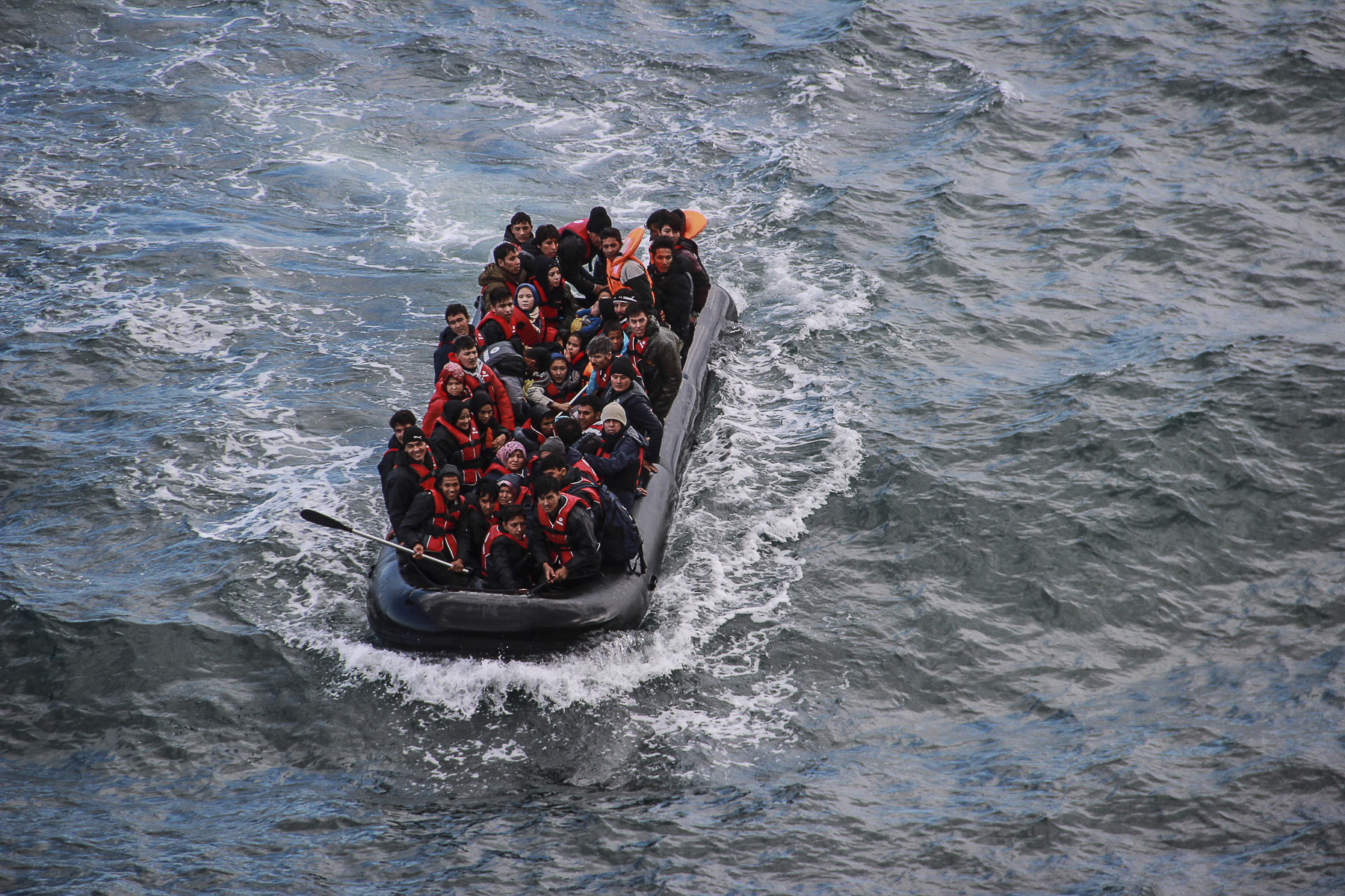   A dinghy carrying refugees from Syria, Iraq and Afghanistan arrives to the shores of Lesvos. October 2015.  