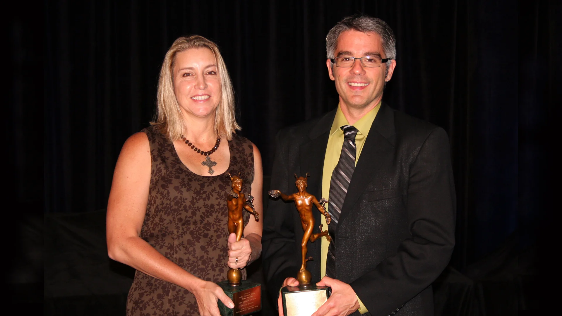 UNDER OUR SKIN Senior Producer Kris Newby and filmmaker Andy Abrahams Wilson receive trophies at the International Health & Medical Media Awards.
