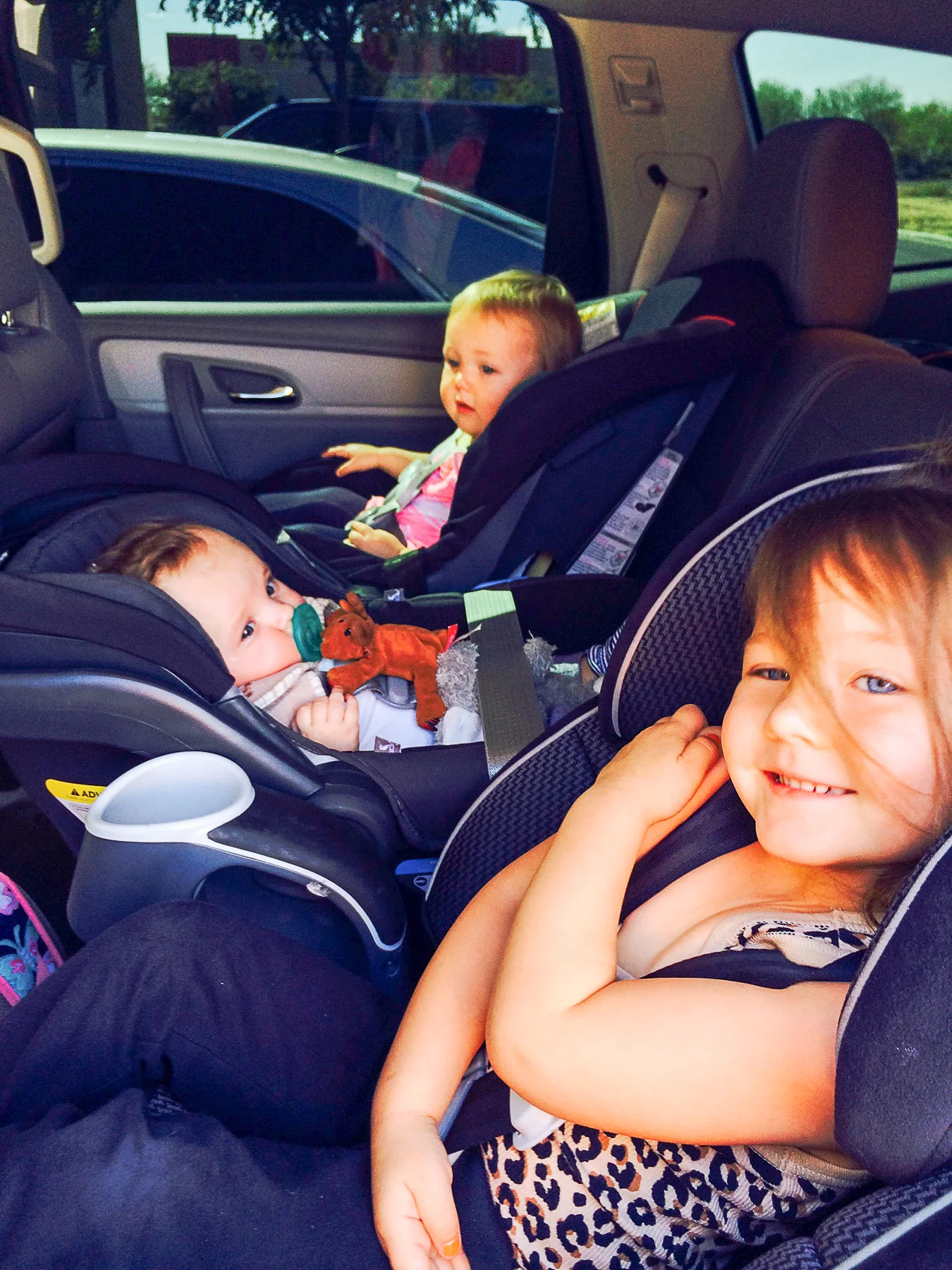 Riding between cousins, Grace and Ava.