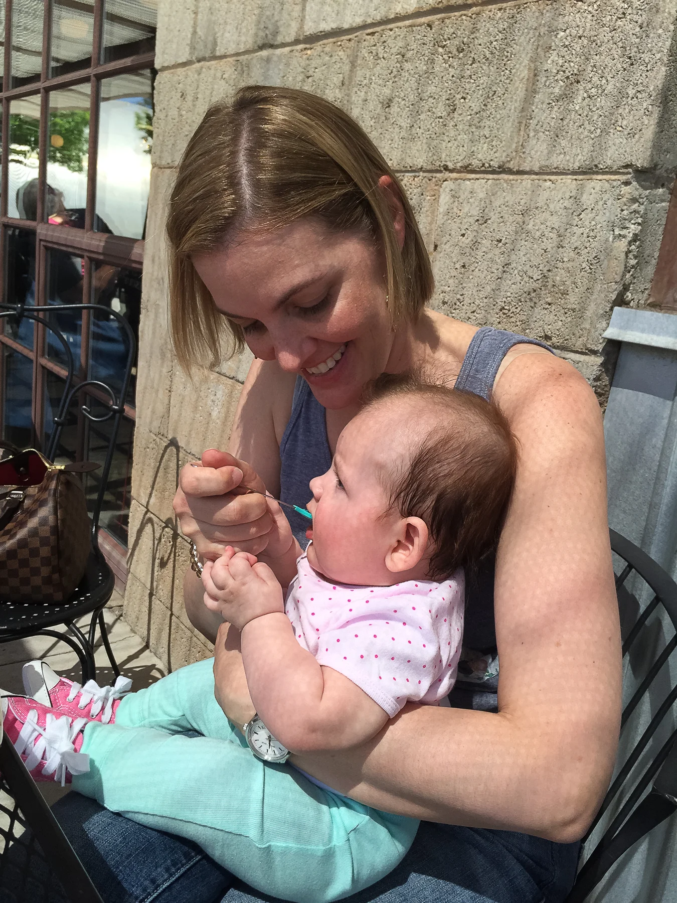 Momma feeding Lydia applesauce. Right after this photo was taken Adam jumped up and performed the Heimlich on an elderly woman next to our table. She ended up being fine!