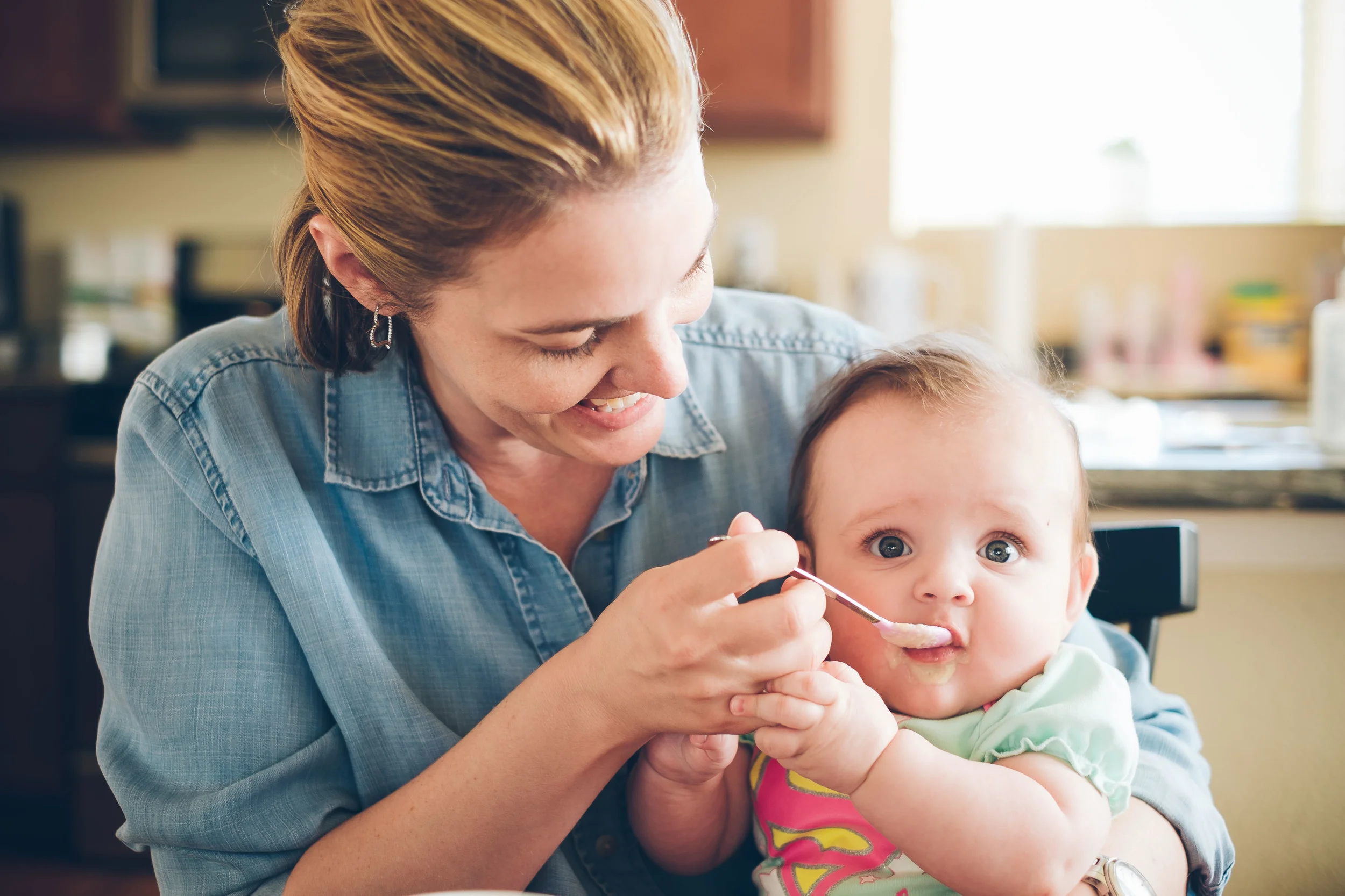 Eating a mixture of brown rice cereal, banana, and squash.