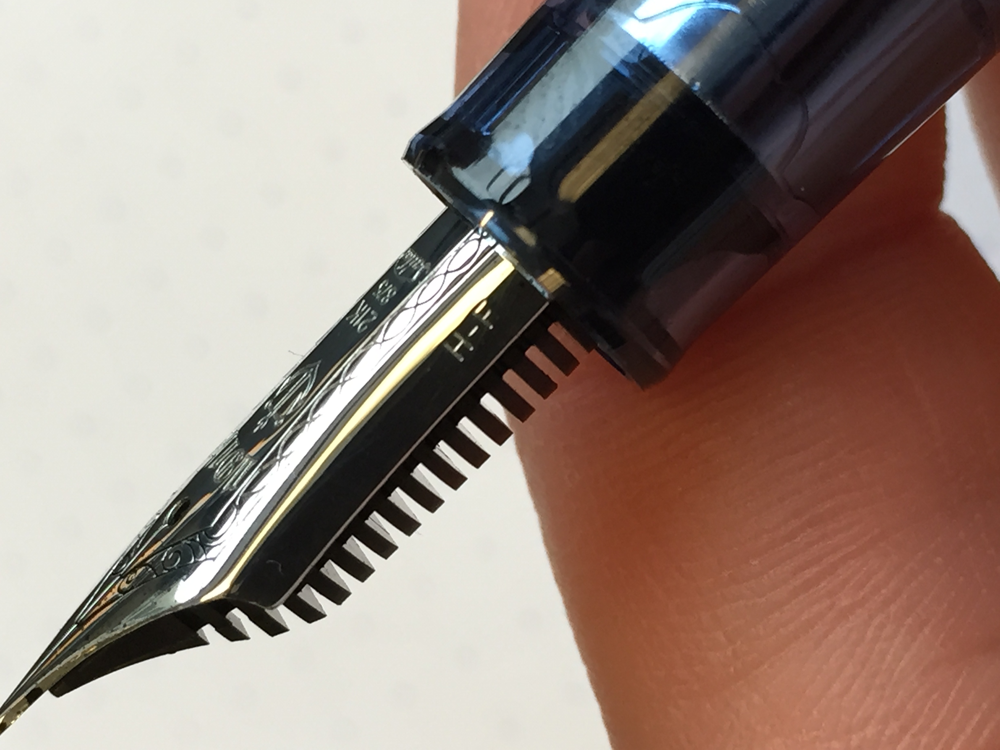 The size of Sailor nibs is etched onto the side. This one is a "Hard Fine", designated "HF". The "Soft Fine" has a bit more spring to it, but is not quite flexible. 