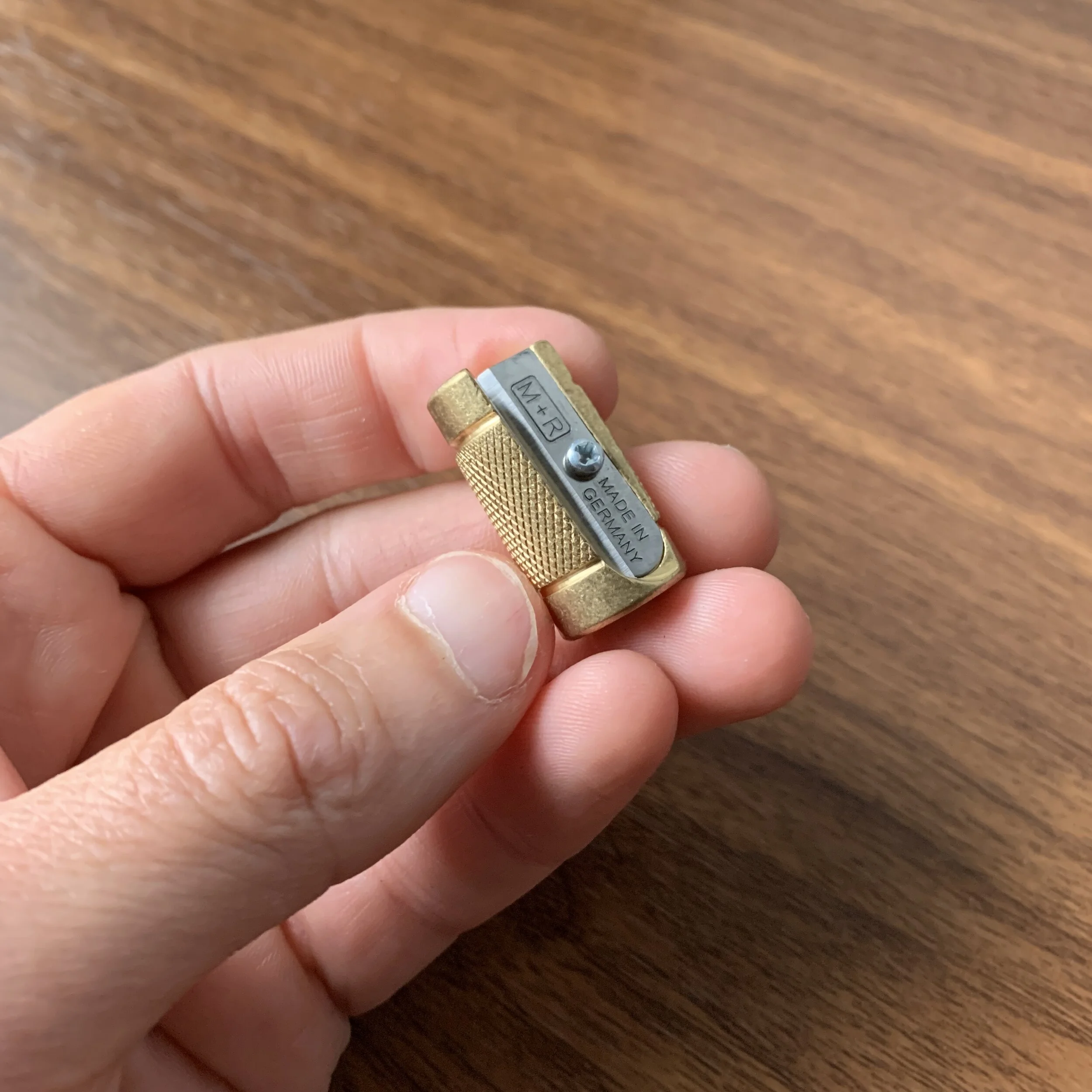 M&R Castor Brass Long-Point Sharpener in Hand