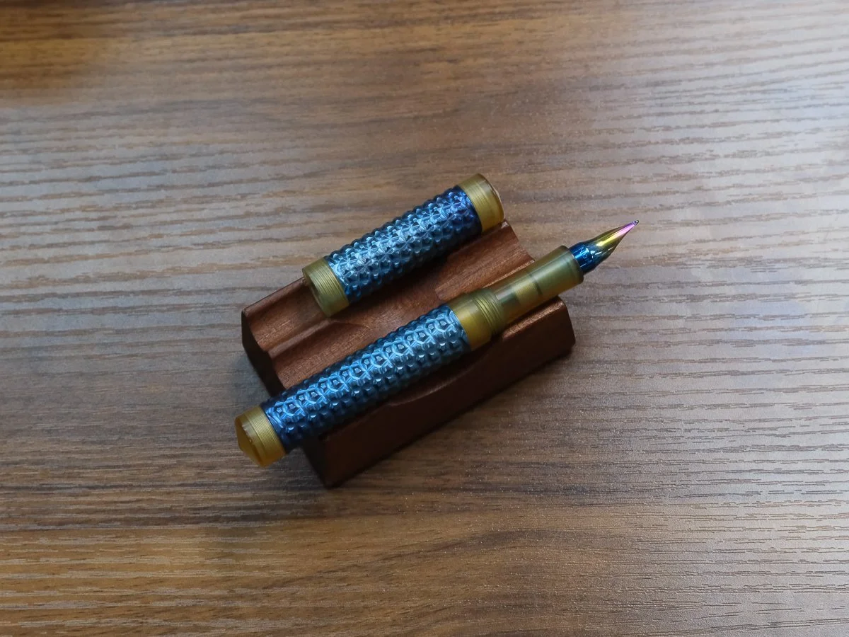 Schon DSGN Faceted Titanium Shell fountain pen with Monoc Nib on Pen Stand
