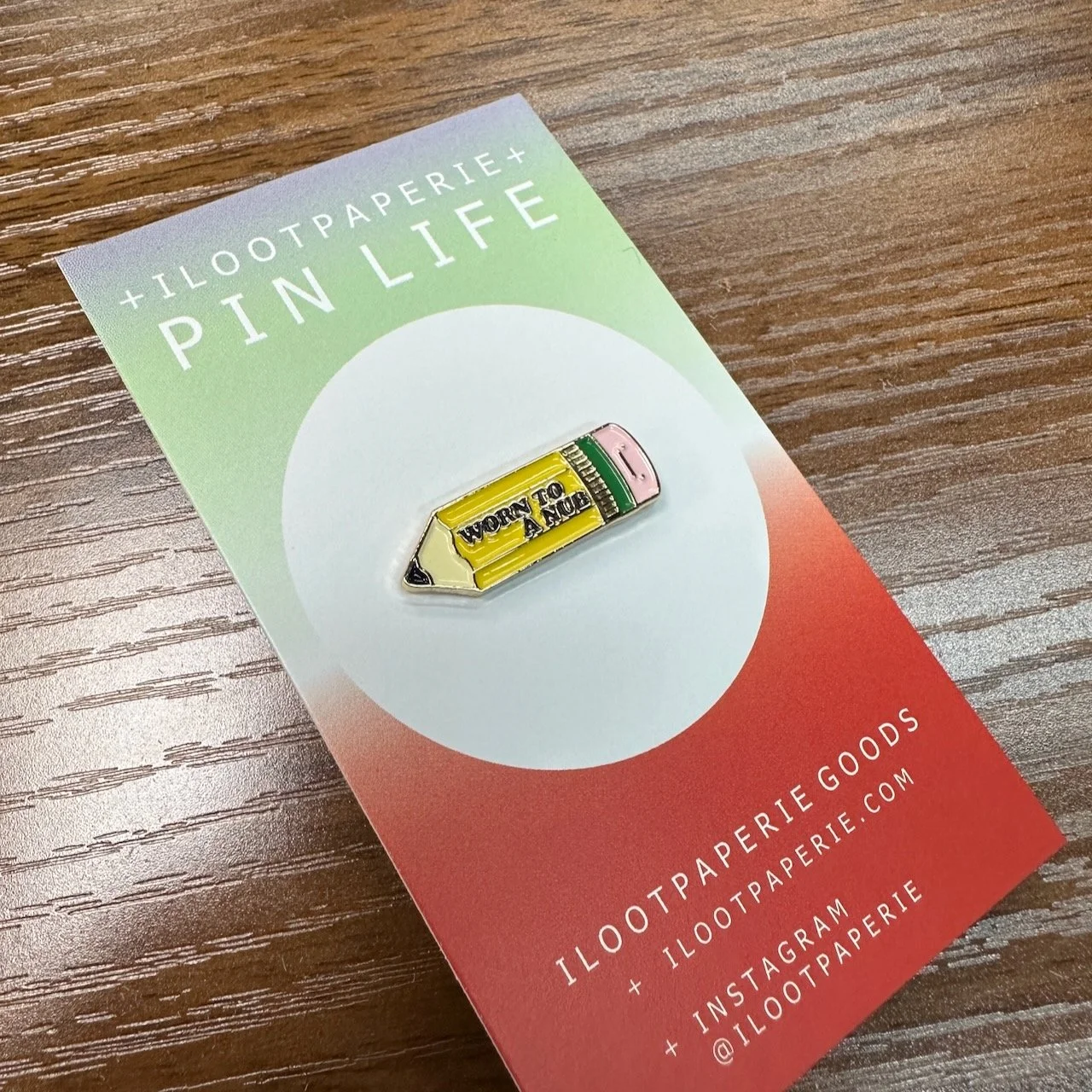 iLootPaperie Worn to a Nub Enamel Pin on Backing