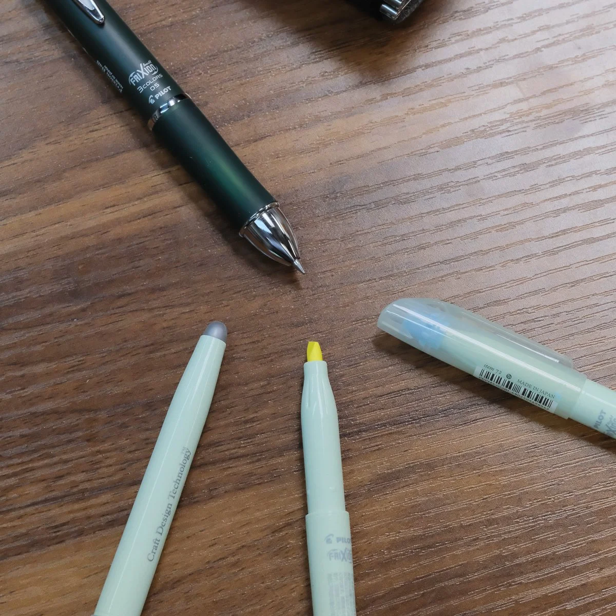 Pilot Frixion Ball 3 Gel Multi Pen shown with uncapped Frixion Highlighters
