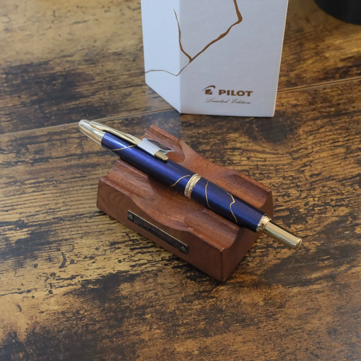 Pilot Vanishing Point Golden Journey Limited Edition Showing Pen on Pen Stand on wood desk
